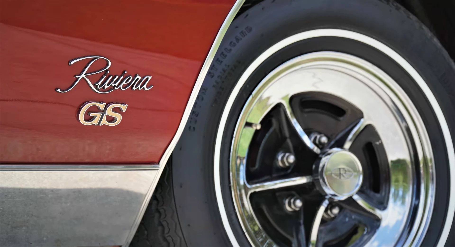 1973 Buick Riviera GS Stage 1 With Rare MaxTrac Traction Control: No Fishtailing In Your Boattail 8 "Riviera GS" badges and chrome road wheel on a red 1973 Buick Riviera