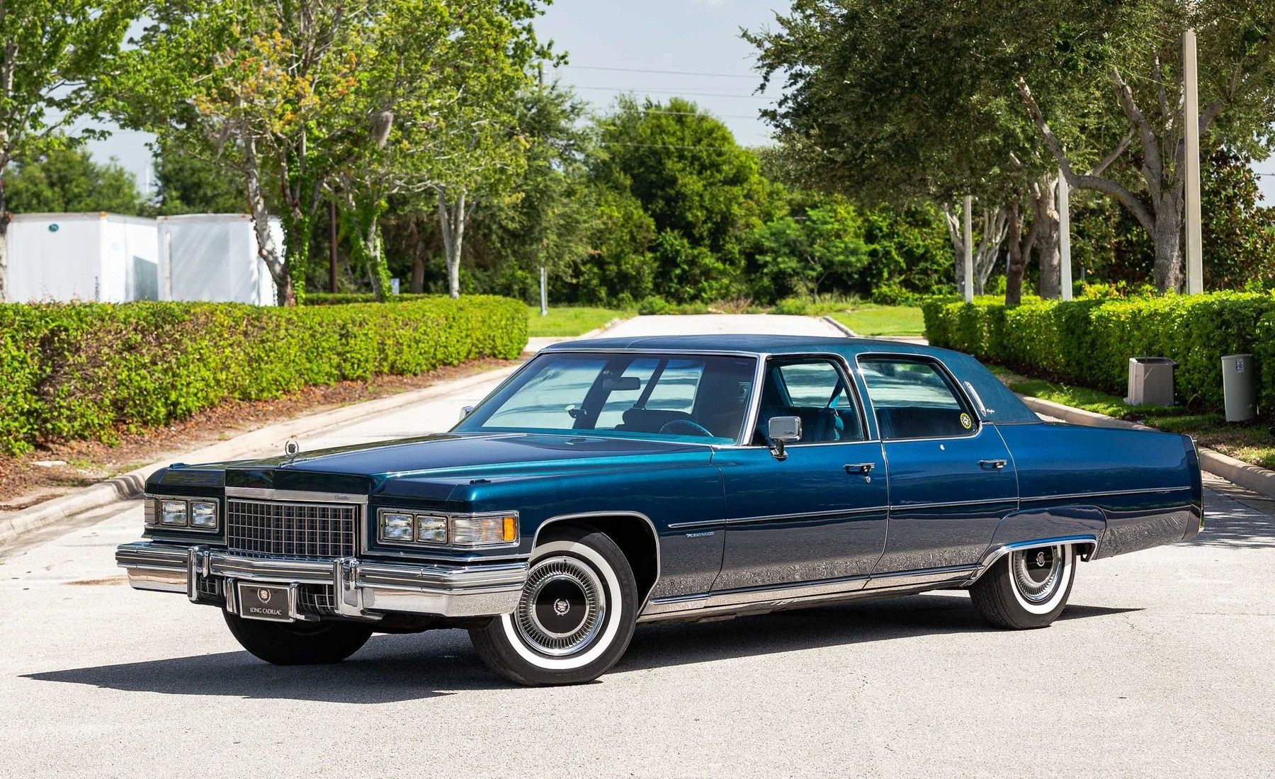 Left front 3q view of a dark blue 1976 Cadillac Fleetwood Brougham four-door sedan