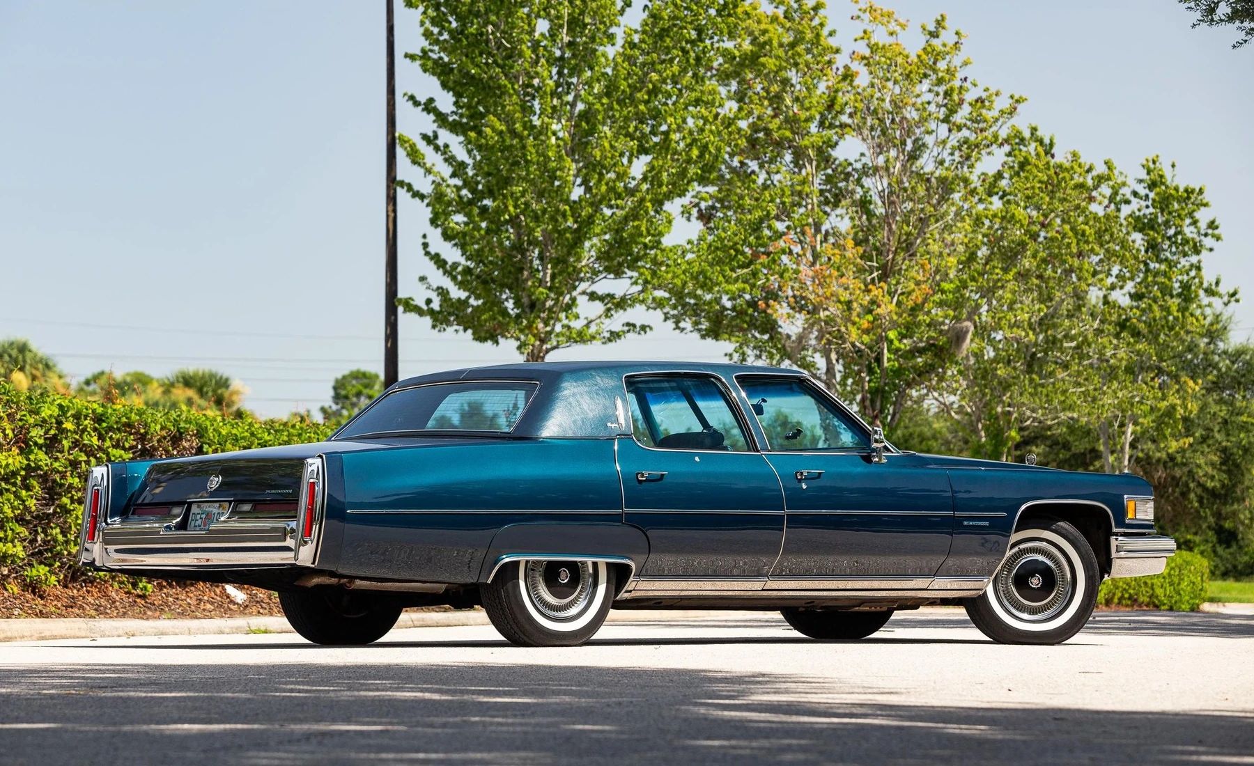 Right rear 3q view of a dark blue 1976 Cadillac Fleetwood Brougham four-door sedan
