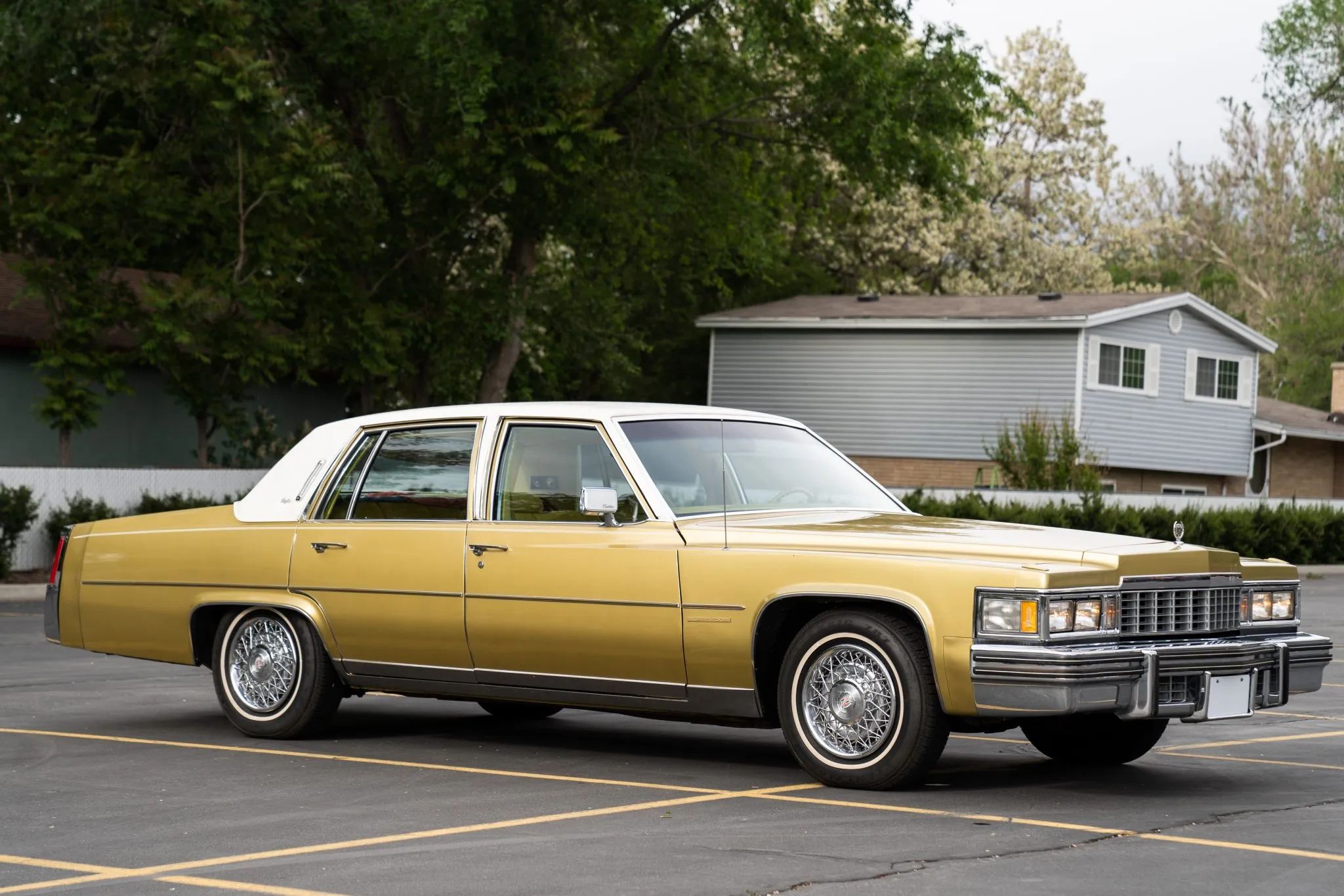 Right front 3q view of a gold 1977 Cadillac four-door sedan