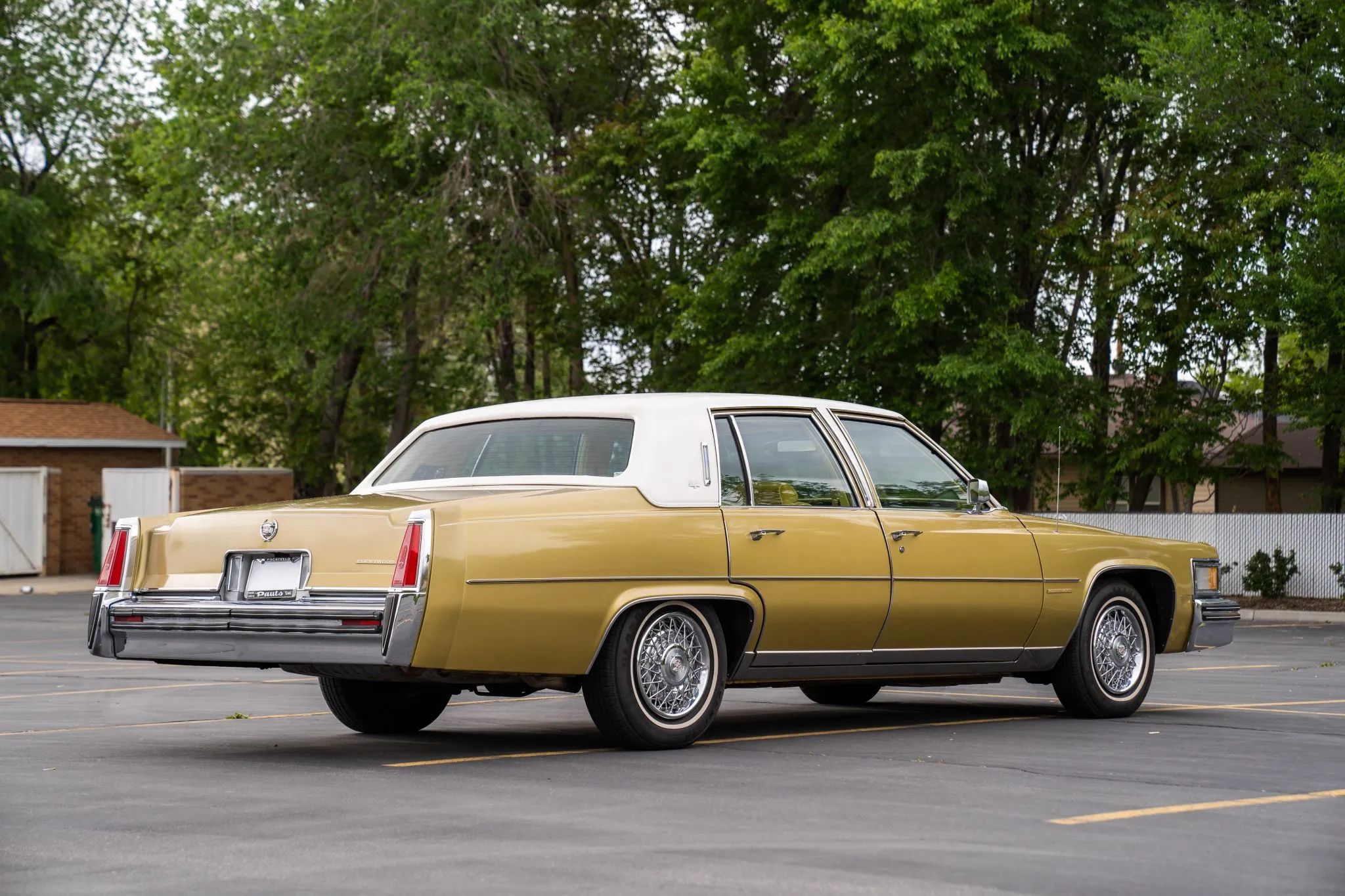 Right rear 3q view of a gold 1977 Cadillac four-door sedan