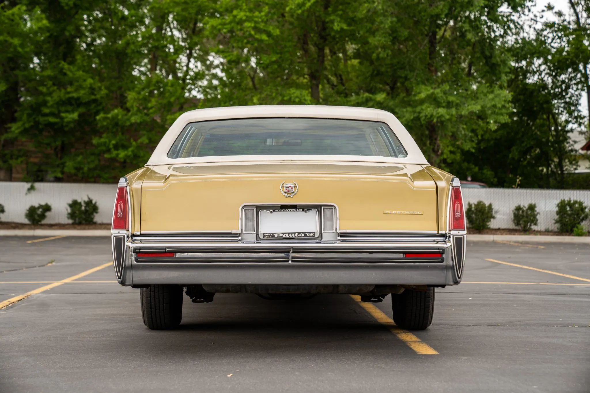 Rear view of a gold 1977 Cadillac sedan