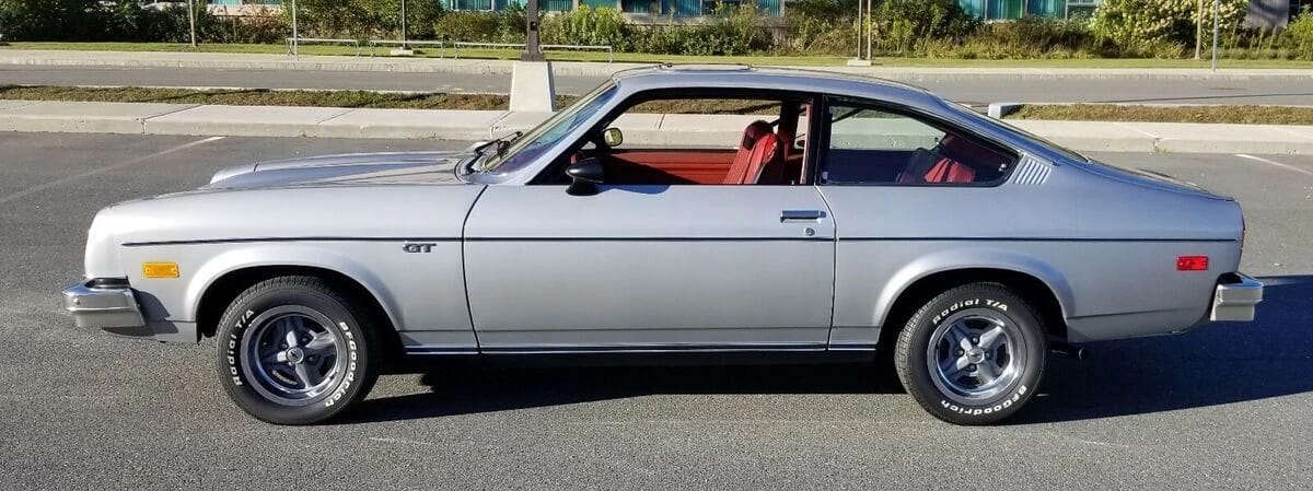 Left side view of a silver 1977 Chevrolet Vega GT hatchback coupe