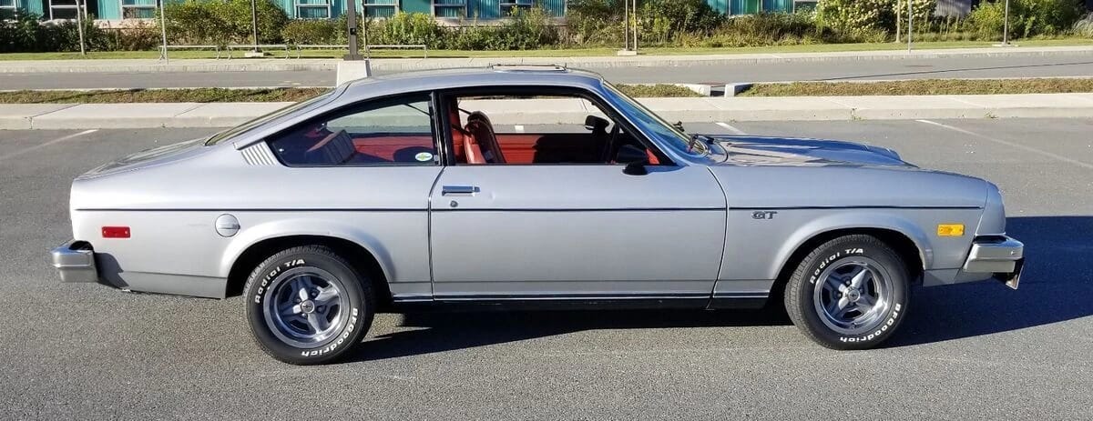 Right side view of a silver 1977 Chevrolet Vega three-door hatchback