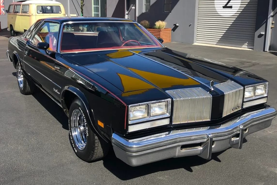 Right front 3q view of a black 1977 Oldsmobile Cutlass Supreme