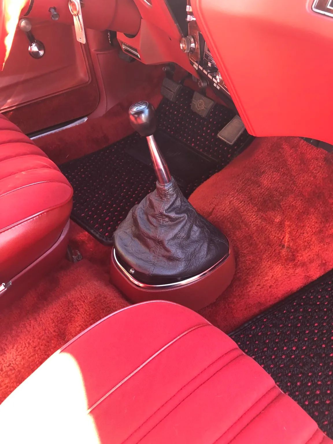 5-speed shifter in a car with red interior