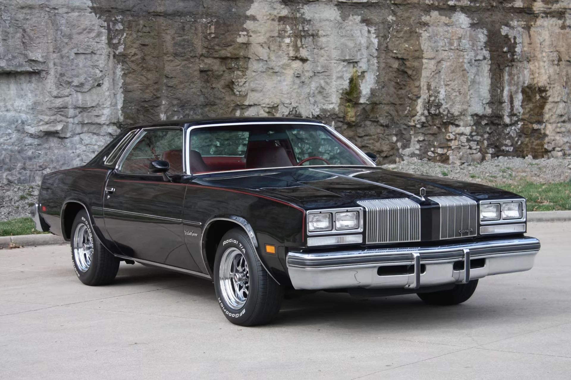 Right front 3q view of a black 1977 Oldsmobile Cutlass Supreme