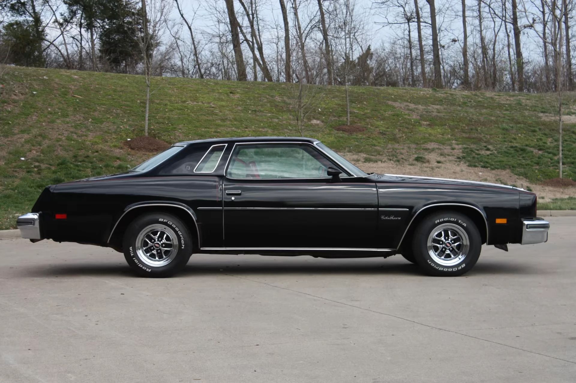 Right side view of a black 1977 Oldsmobile Cutlass Supreme