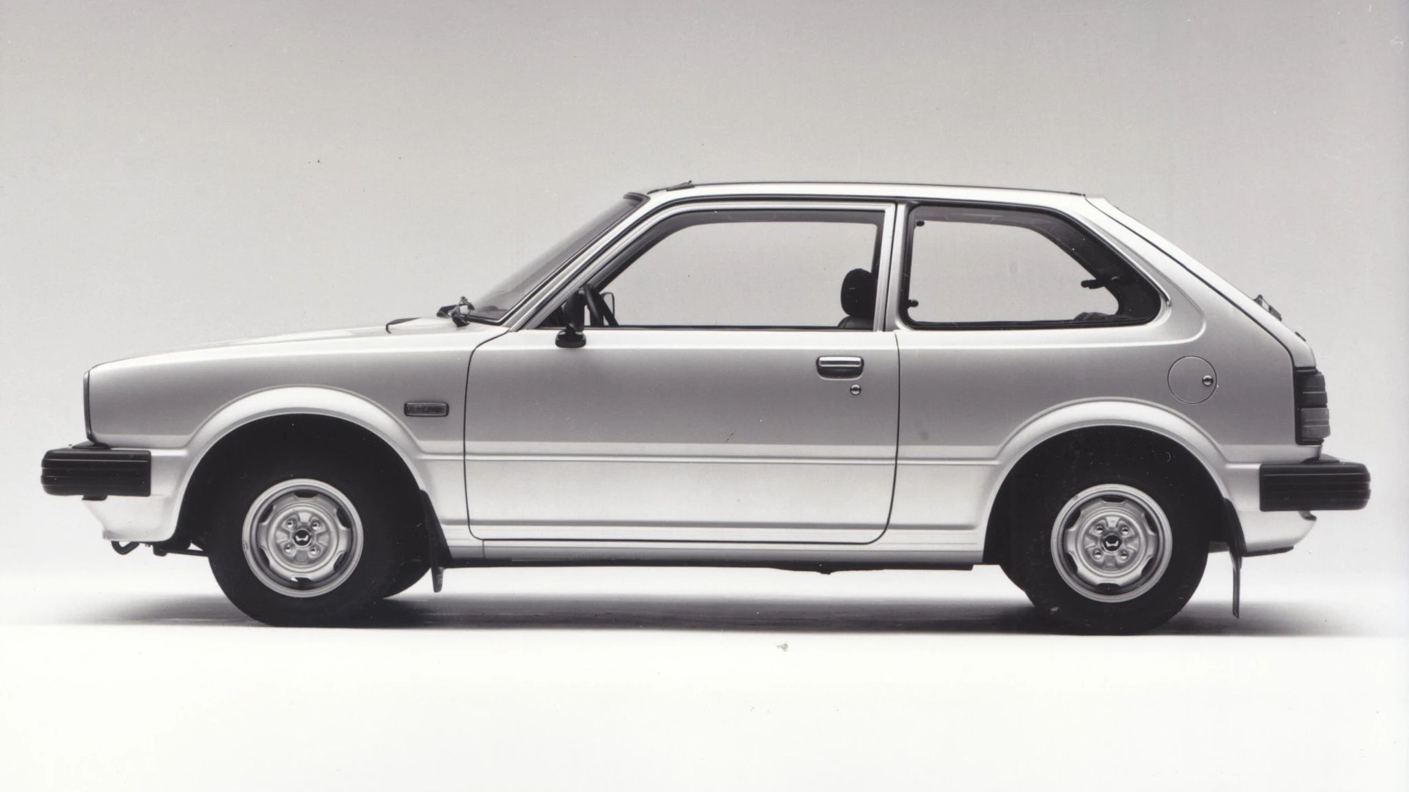 Side view of a silver 1980 Honda Civic hatchback