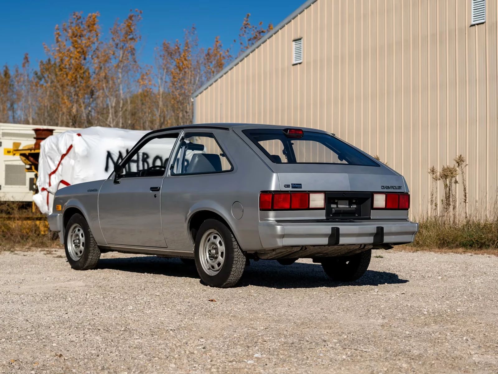 Left rear 3q view of a silver 1987 Chevrolet Chevette hatchback