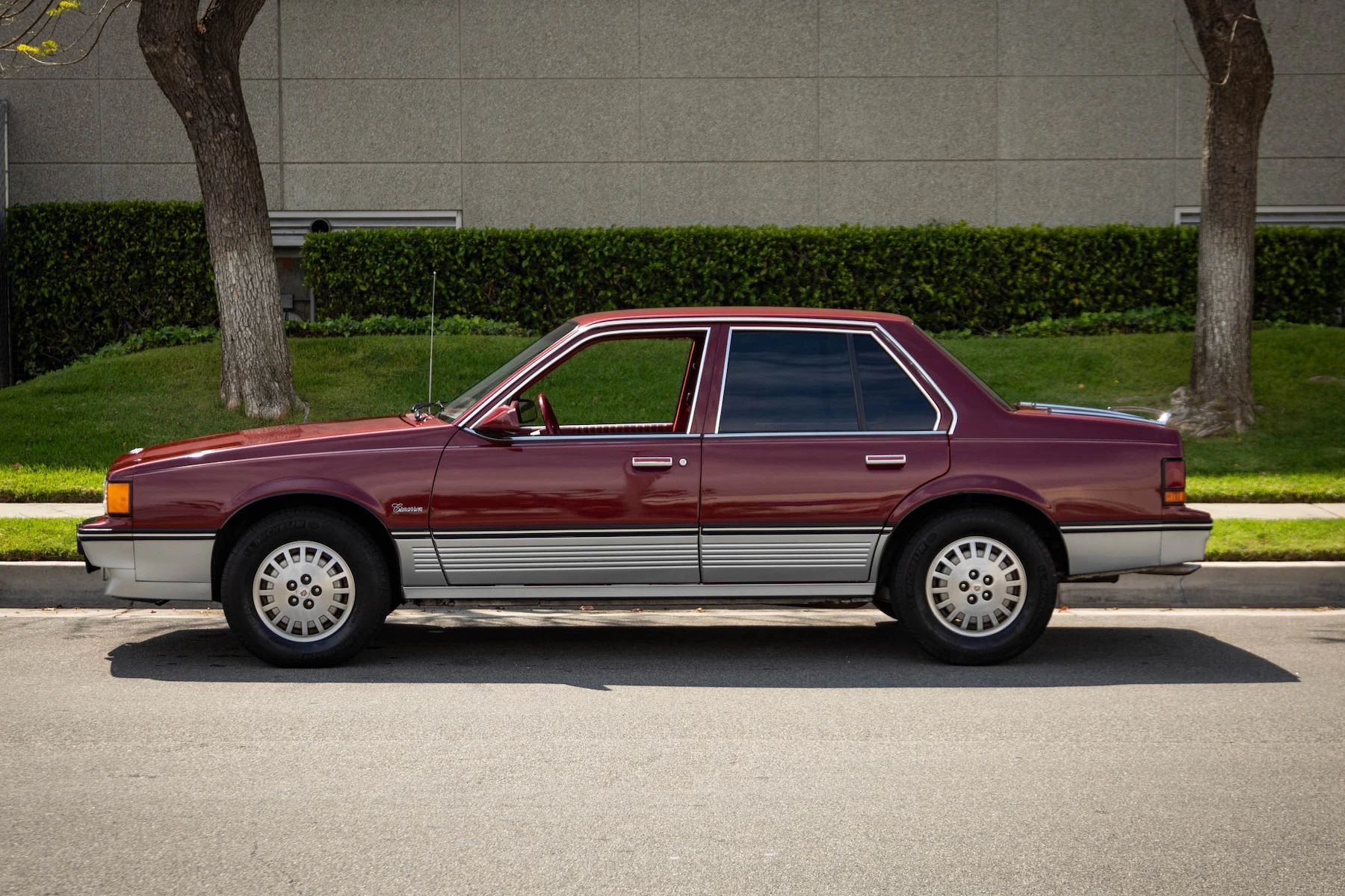 1988 Cadillac Cimarron: The Nicest Surviving Example Of Cadillac's Most Embarrassing Car 10 Left side view of a red 1988 Cadillac Cimarron
