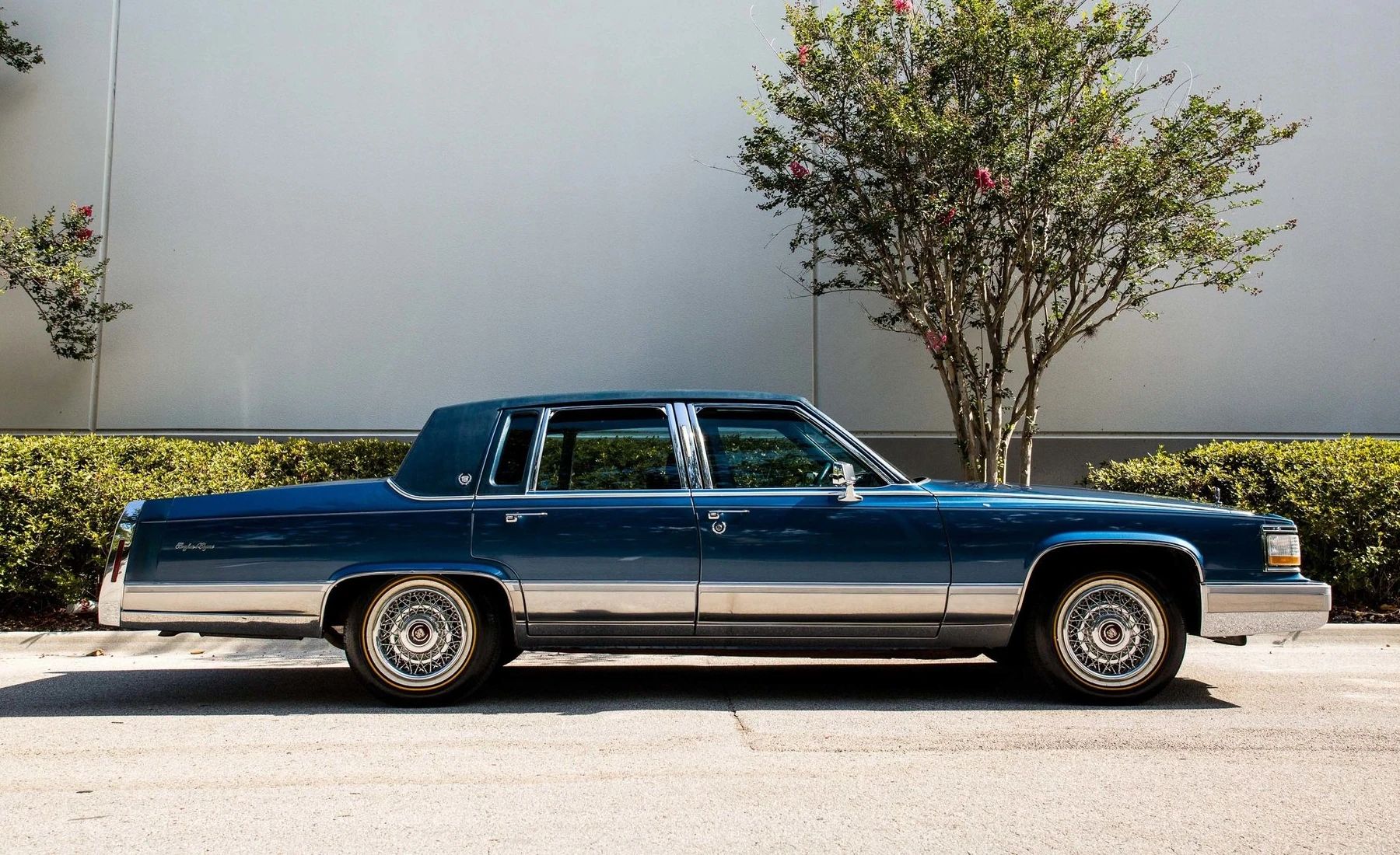 Right side view of a dark blue 1991 Cadillac Brougham four-door sedan