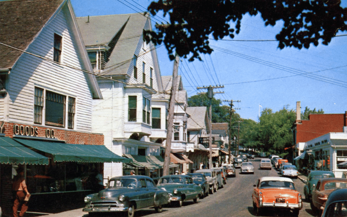 Vintage 1950s & 1960s Postcards of American Downtowns 1 Vintage color photo of cars on a city street sometime in the 1950s