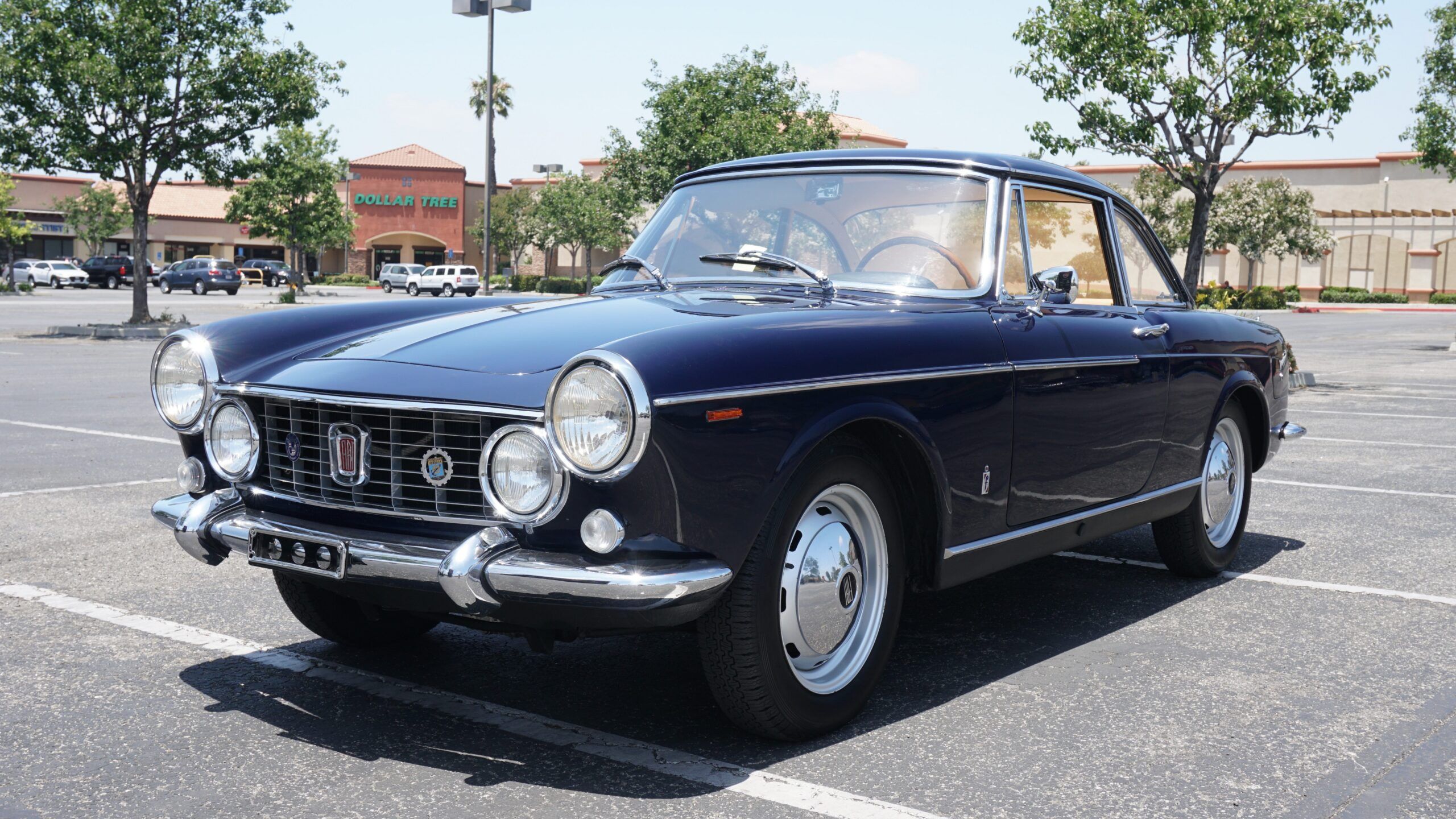 Pininfarina's Shared Language of Beauty in 1963—From Ferrari to FIAT 8 Photo of dark blue FIAT 1600S Coupe in a parking lot