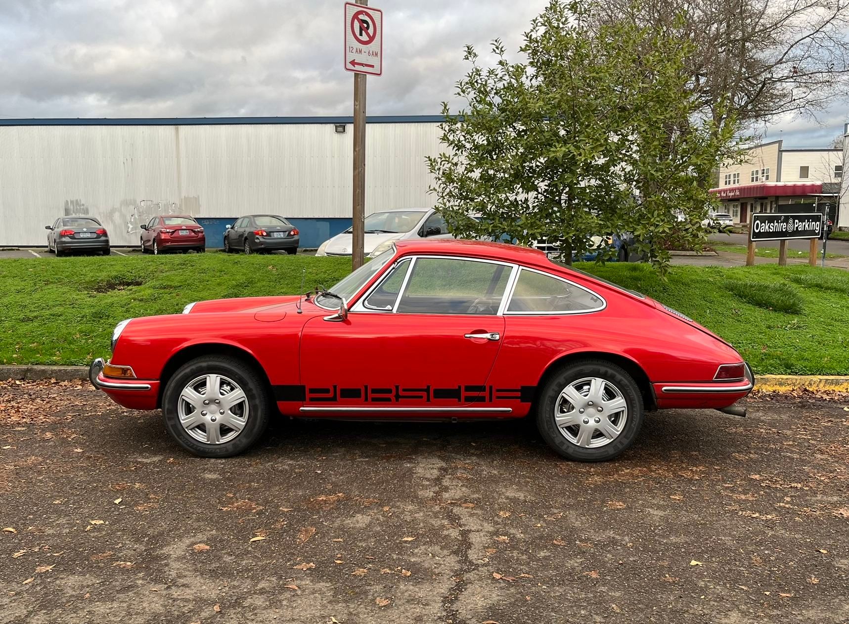 This Classic Porsche 912 Is Wearing Cheap Plastic Wheel Covers! The Ultimate Porsche Sacrilege? 1 Photo of a red 1968 Porsche 912 with cheap plastic wheel covers