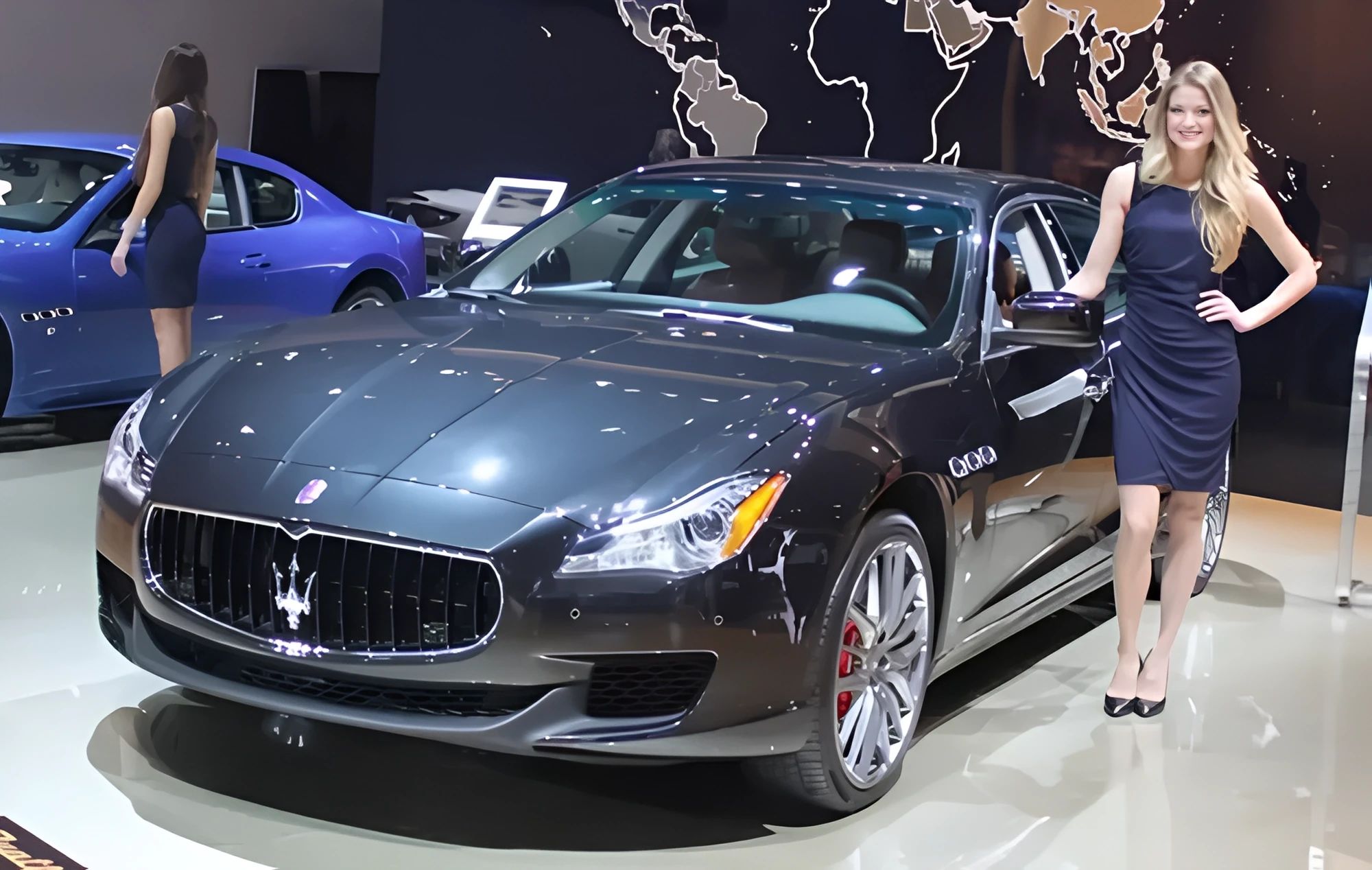 2009–2012 Maserati Quattroporte: Should I Buy One? 1 Photo of a female model standing next to a dark gray 2009 Maserati Quattroporte sedan