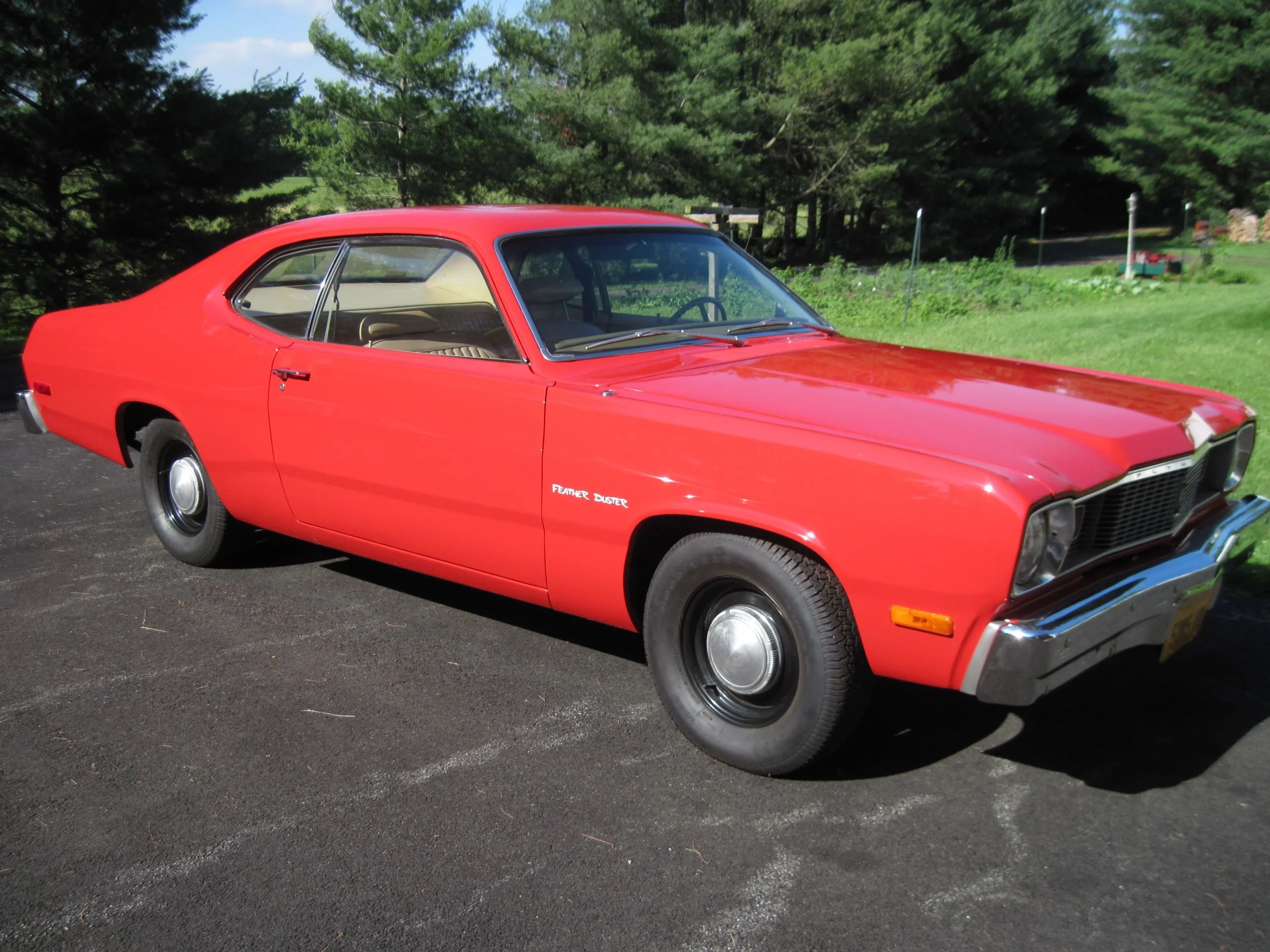 Photo of a bright red 1976 Plymouth Feather Duster