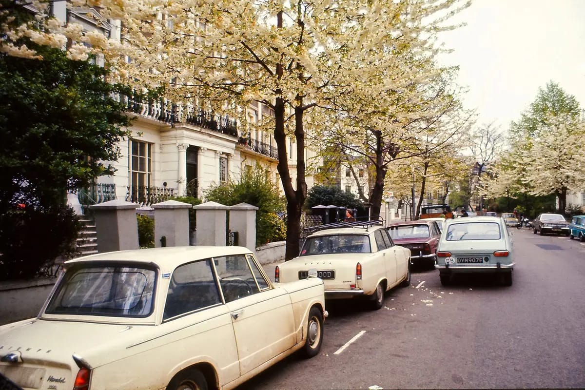 Vintage Photos: Cars And Street Scenes In London - 1940s - 1970s 1 Old color photo of British cars parked on the left side of a street in West London