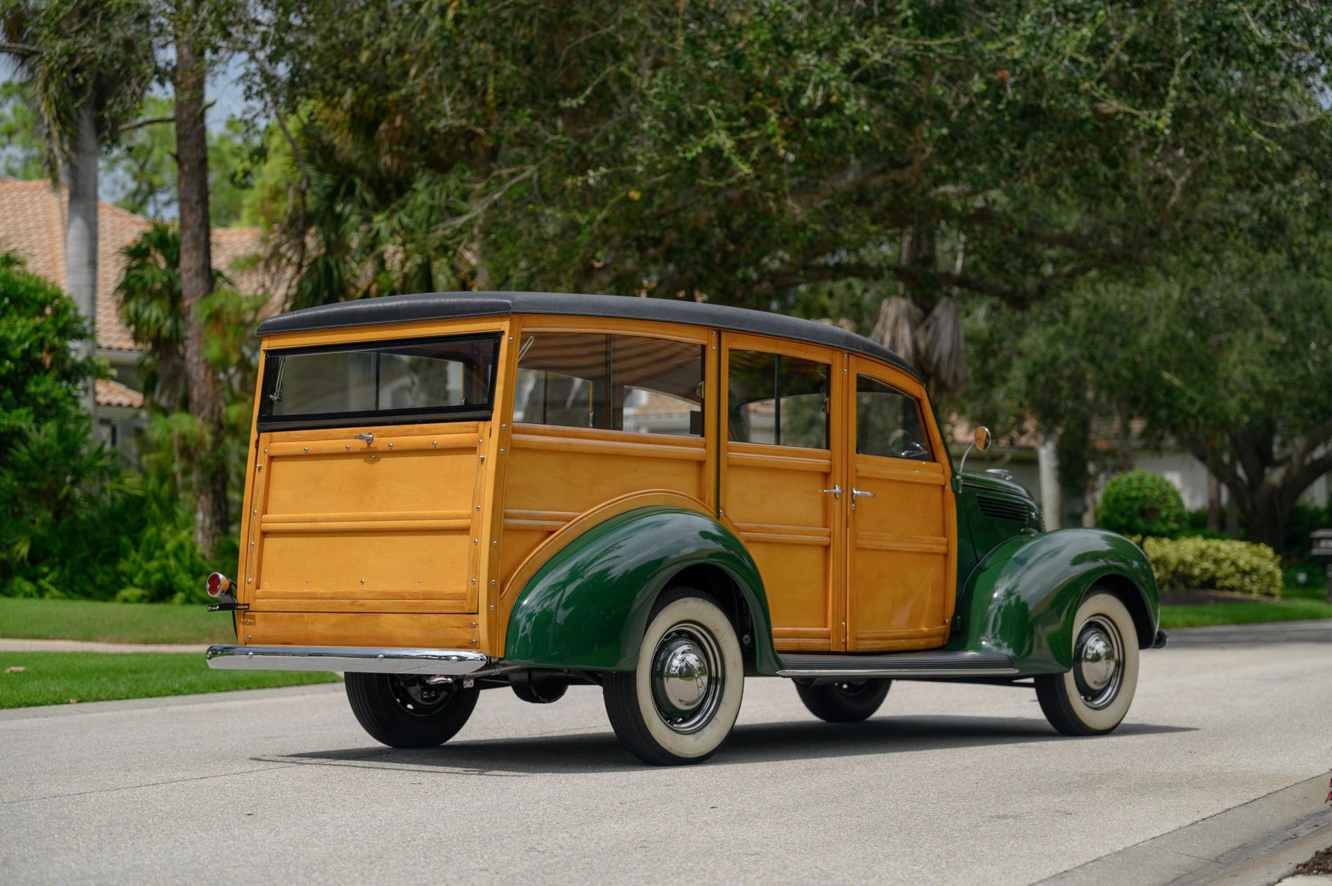 Right rear 3q view of a green 1938 Ford wood-bodied station wagon