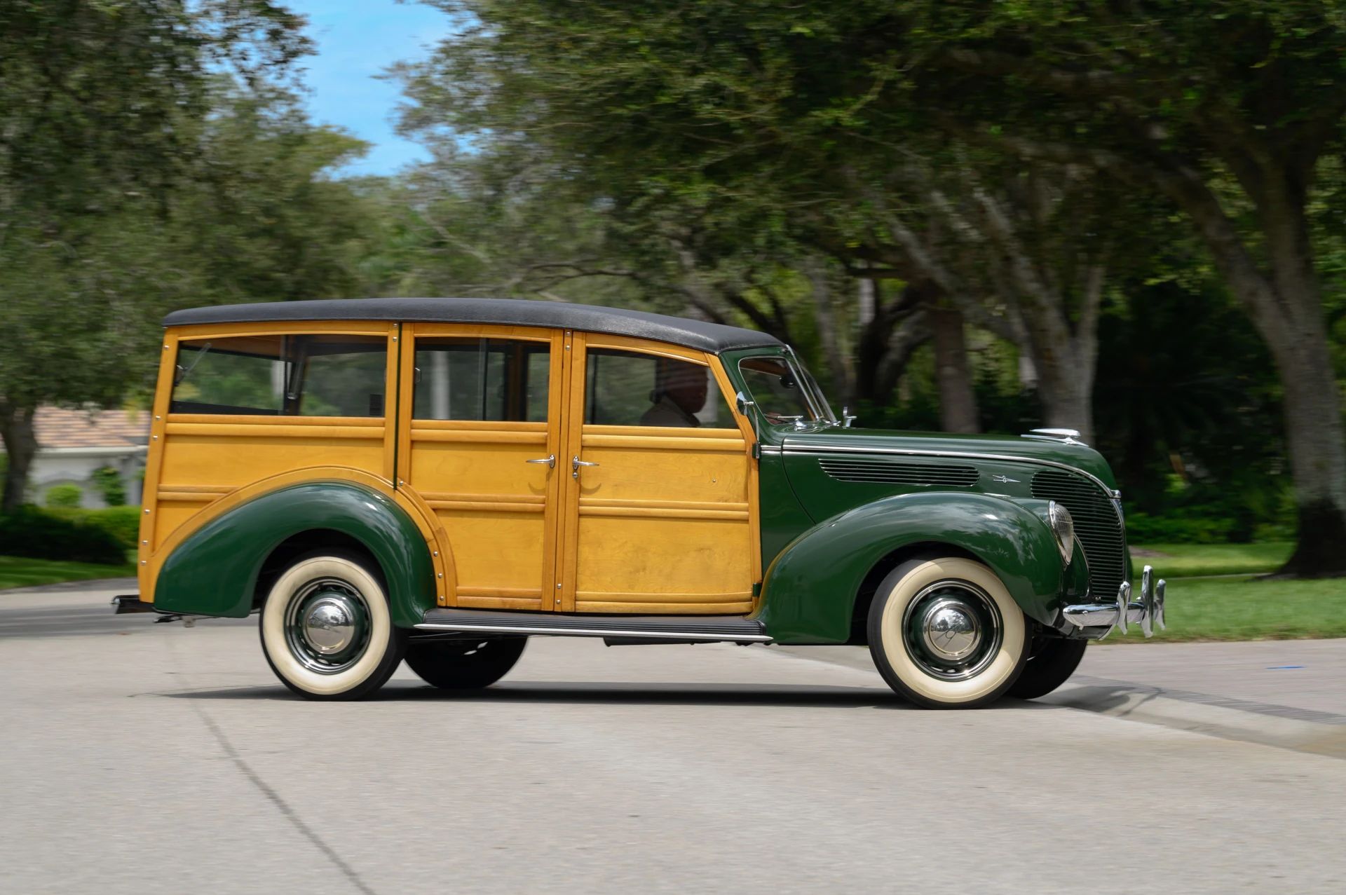 Right side view of a green 1938 Ford wood-bodied station wagon