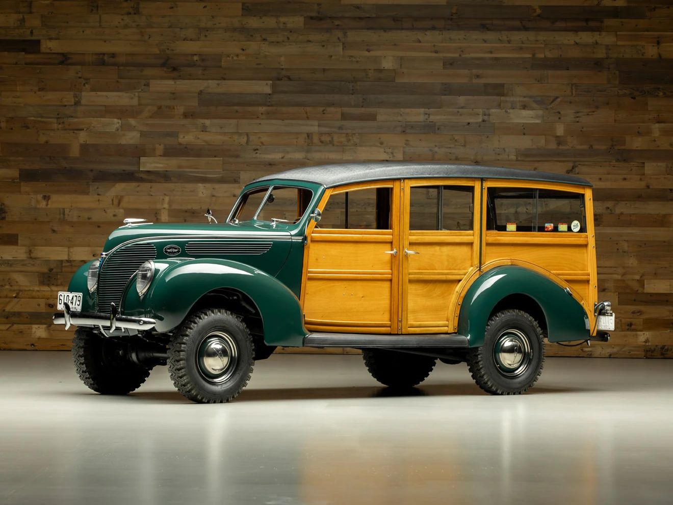 Left front 3q view of a green 1938 Ford wood-bodied station wagon with a 4WD conversion and large tires