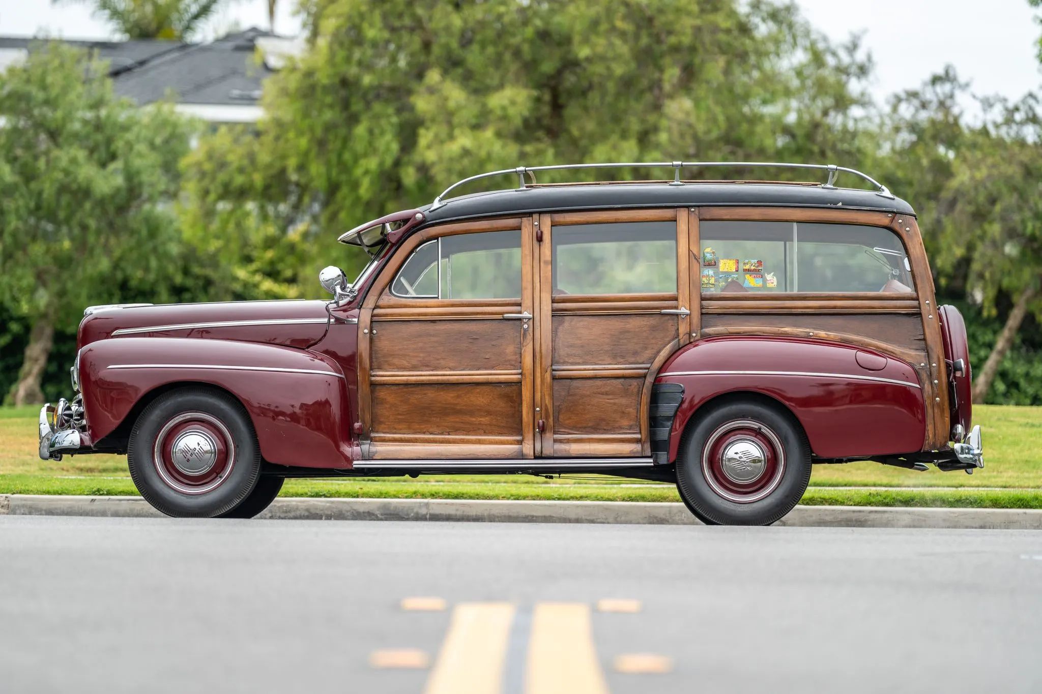 Left side view of a maroon 1946 Ford wood-bodied station wagon