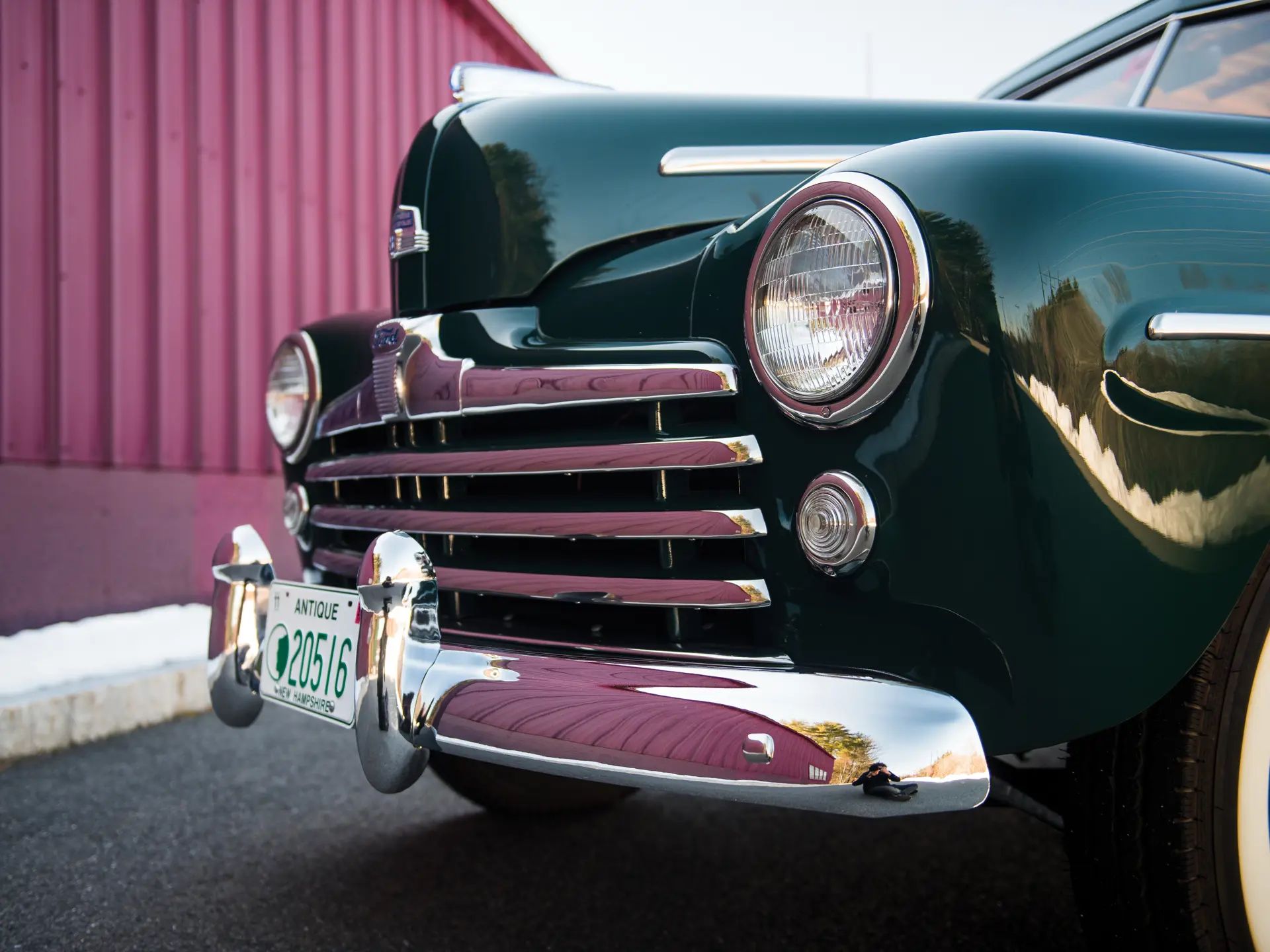Front end of a dark green 1947 Ford station wagon