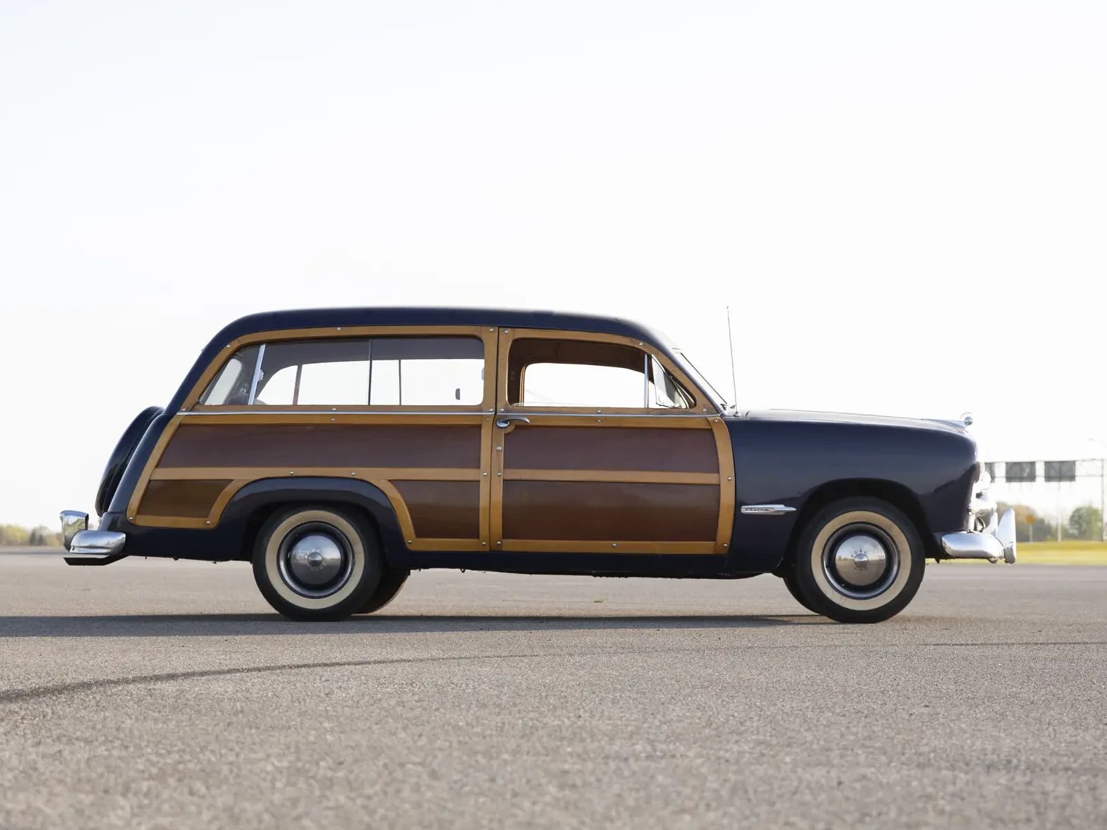 Right side of a dark blue 1949 Ford station wagon