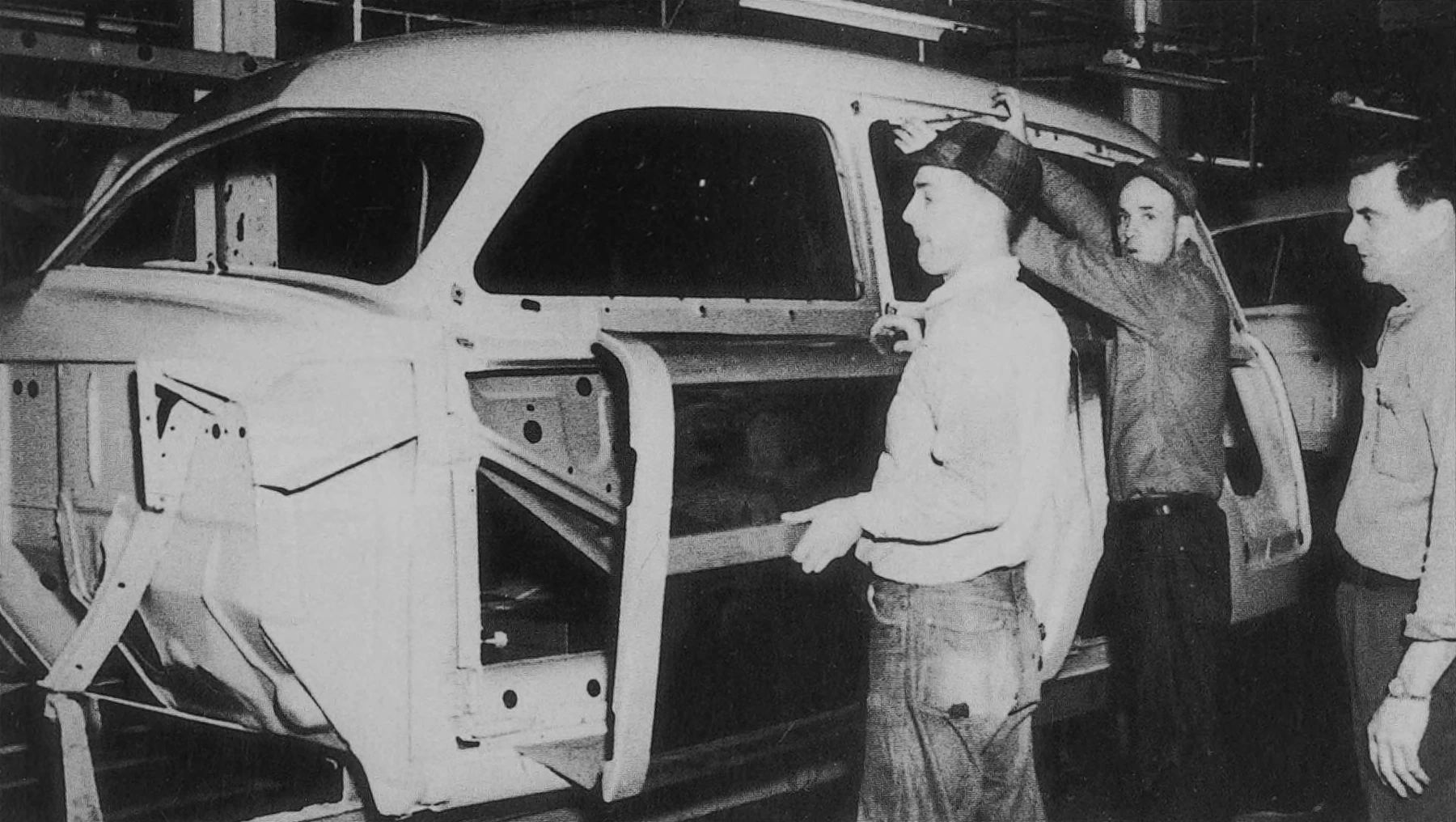 B&W photos of workers attaching a wood outer section to a 1949 Ford station wagon