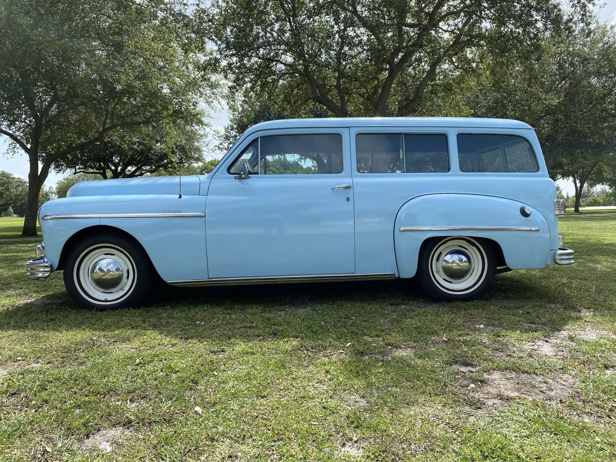 Left side of a light blue 1949 Plymouth station wagon