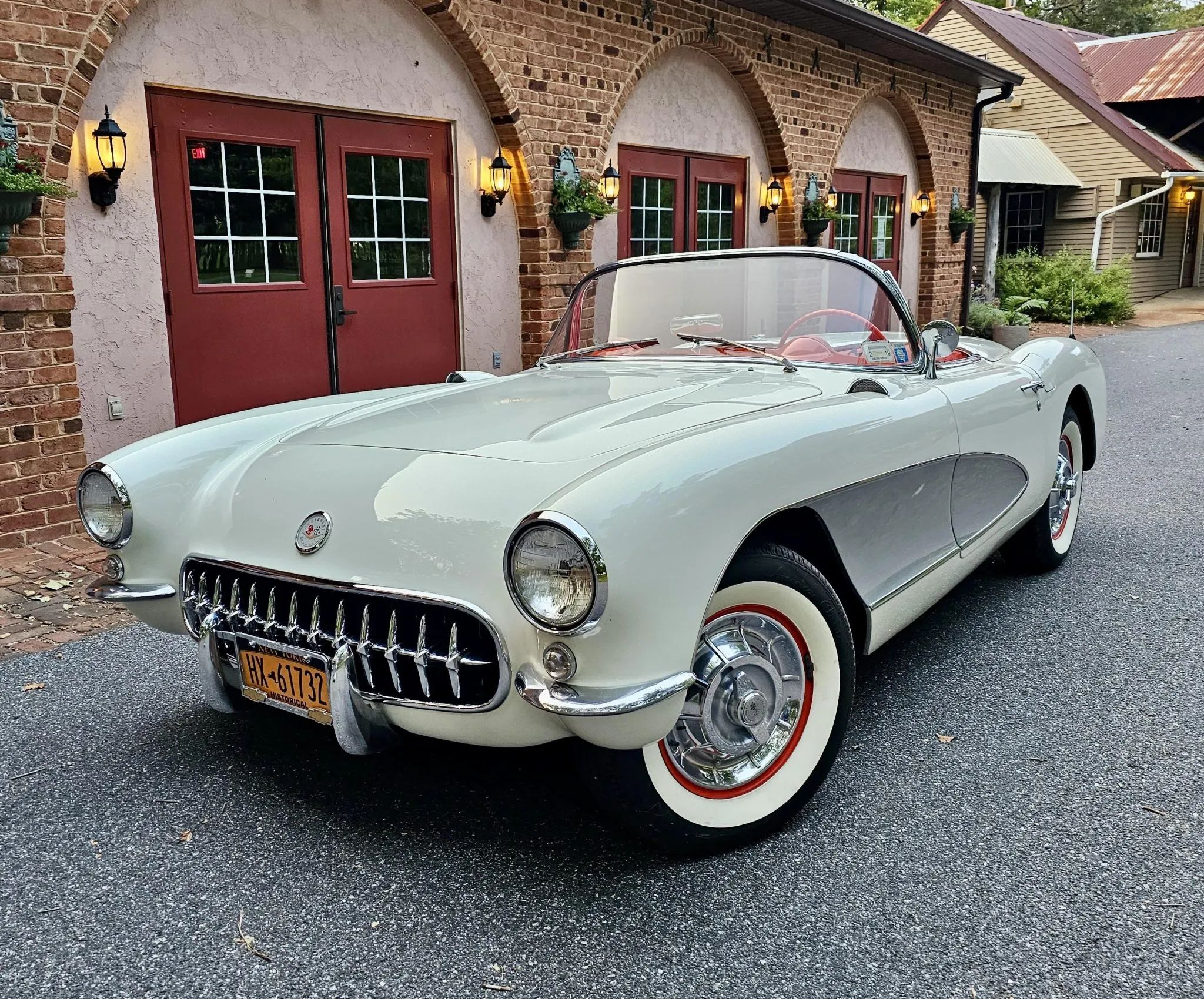 Left front 3q view of a white 1956 Chevrolet Corvette with silver side coves