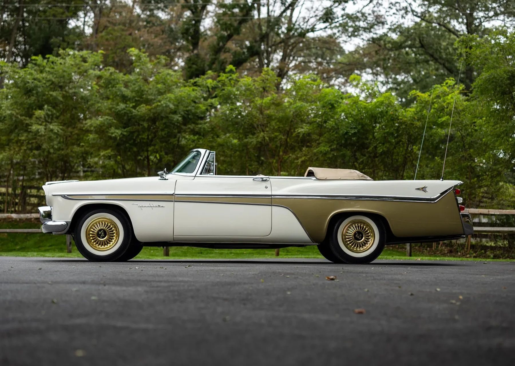 Left side view of a white over gold 1956 DeSoto convertible with the top down