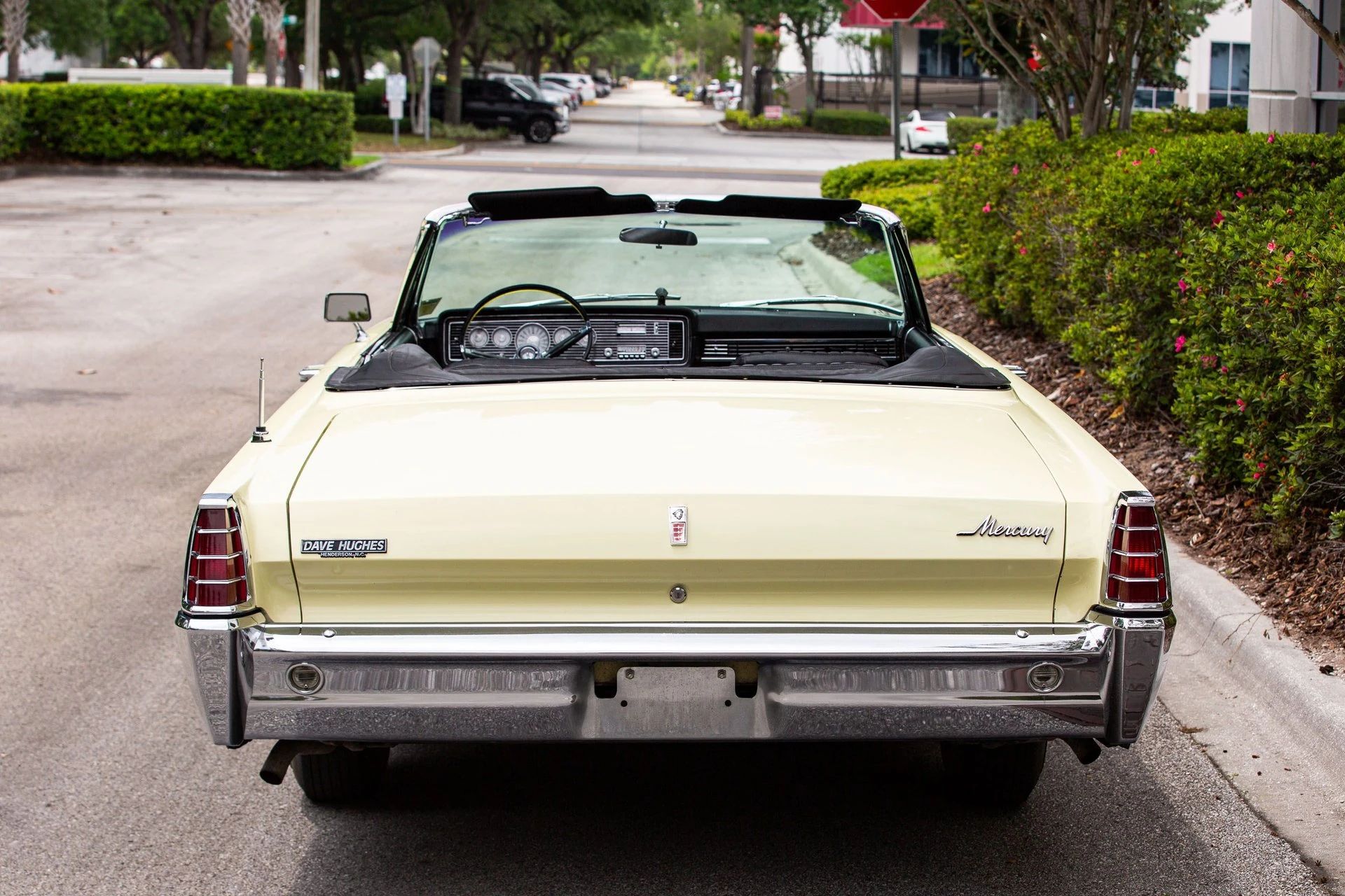 Rear view of a yellow 1966 Mercury convertible with the top down