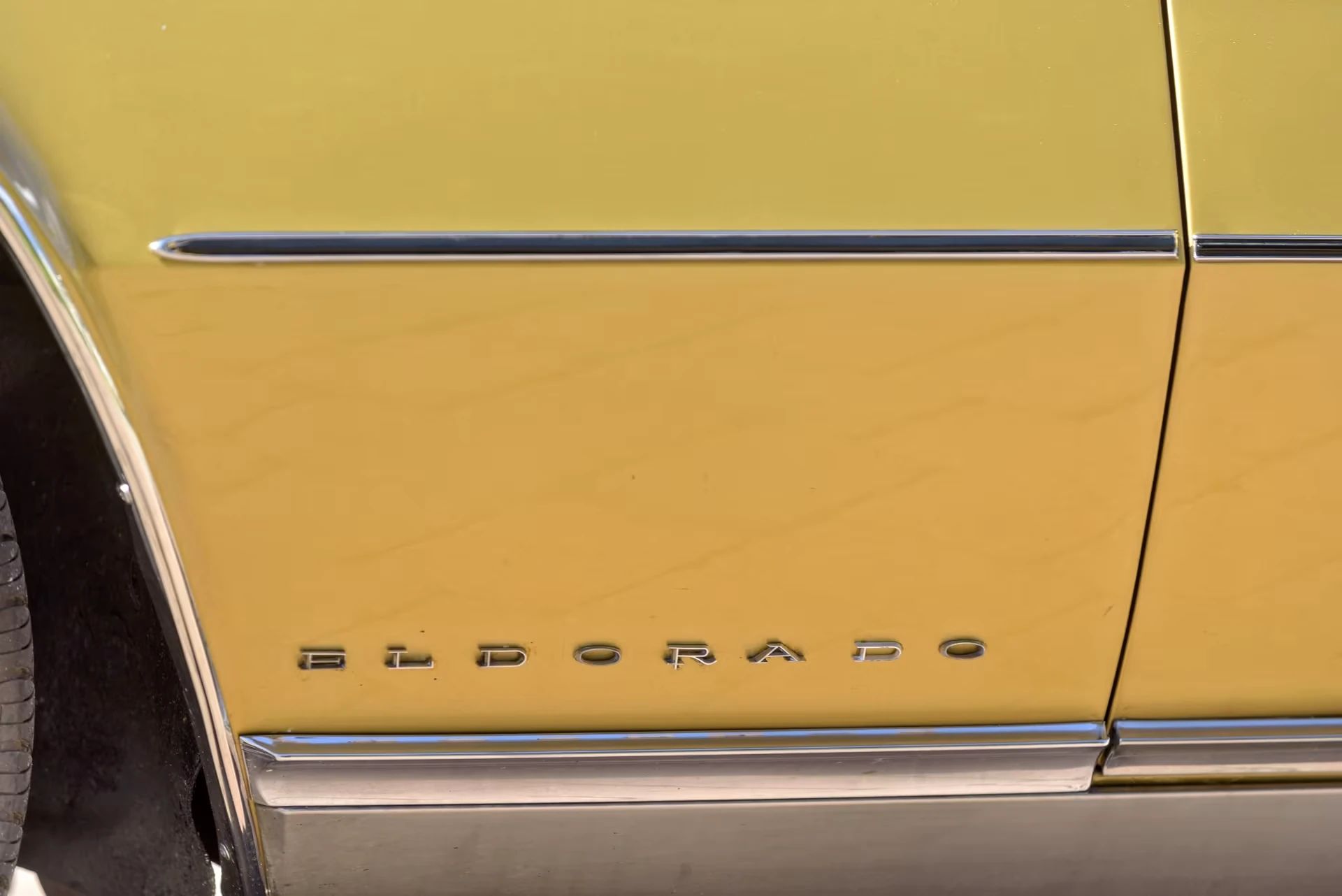 Vintage C/D Review: 1970 Cadillac Eldorado Was Powerful, Pricey, and Prestigious – So, Why Did They Photograph It Outside A Check-Cashing Place? 6 "ELDORADO" lettering on the front fender of a gold 1970 Cadillac
