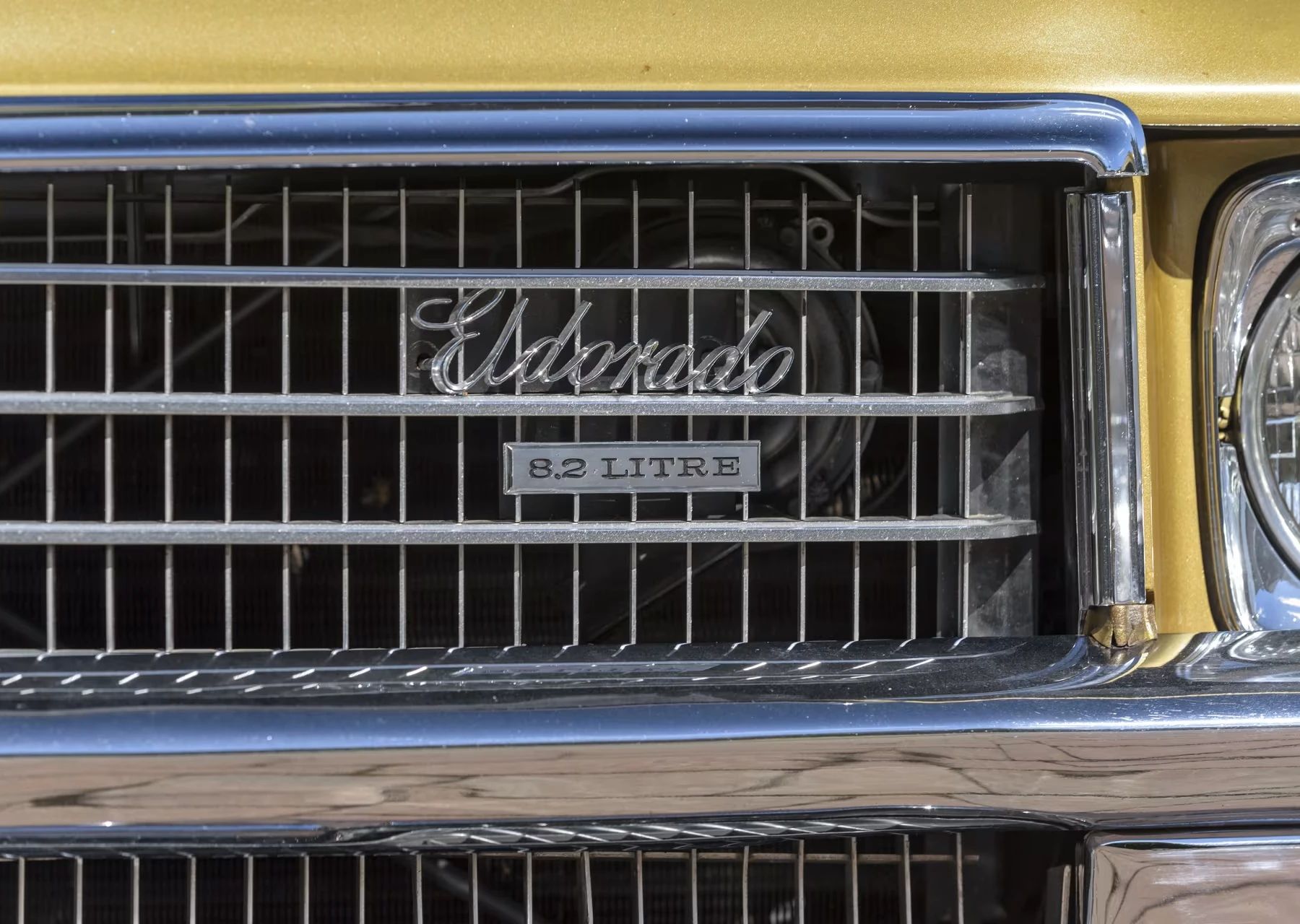 Vintage C/D Review: 1970 Cadillac Eldorado Was Powerful, Pricey, and Prestigious – So, Why Did They Photograph It Outside A Check-Cashing Place? 11 "Eldorado 8.2 Litre" badges on the grille of a 1970 Eldorado