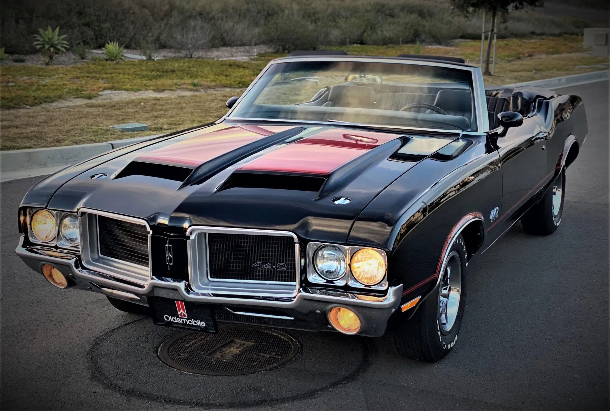 What Really Killed Muscle Cars In The '70s - Two Vintage Articles Try To Explain: "The Insurance Squeeze" And "What Price Muscle" 11 Left front 3q view of a black 1971 Olds 442 convertible with its top down and headlights on