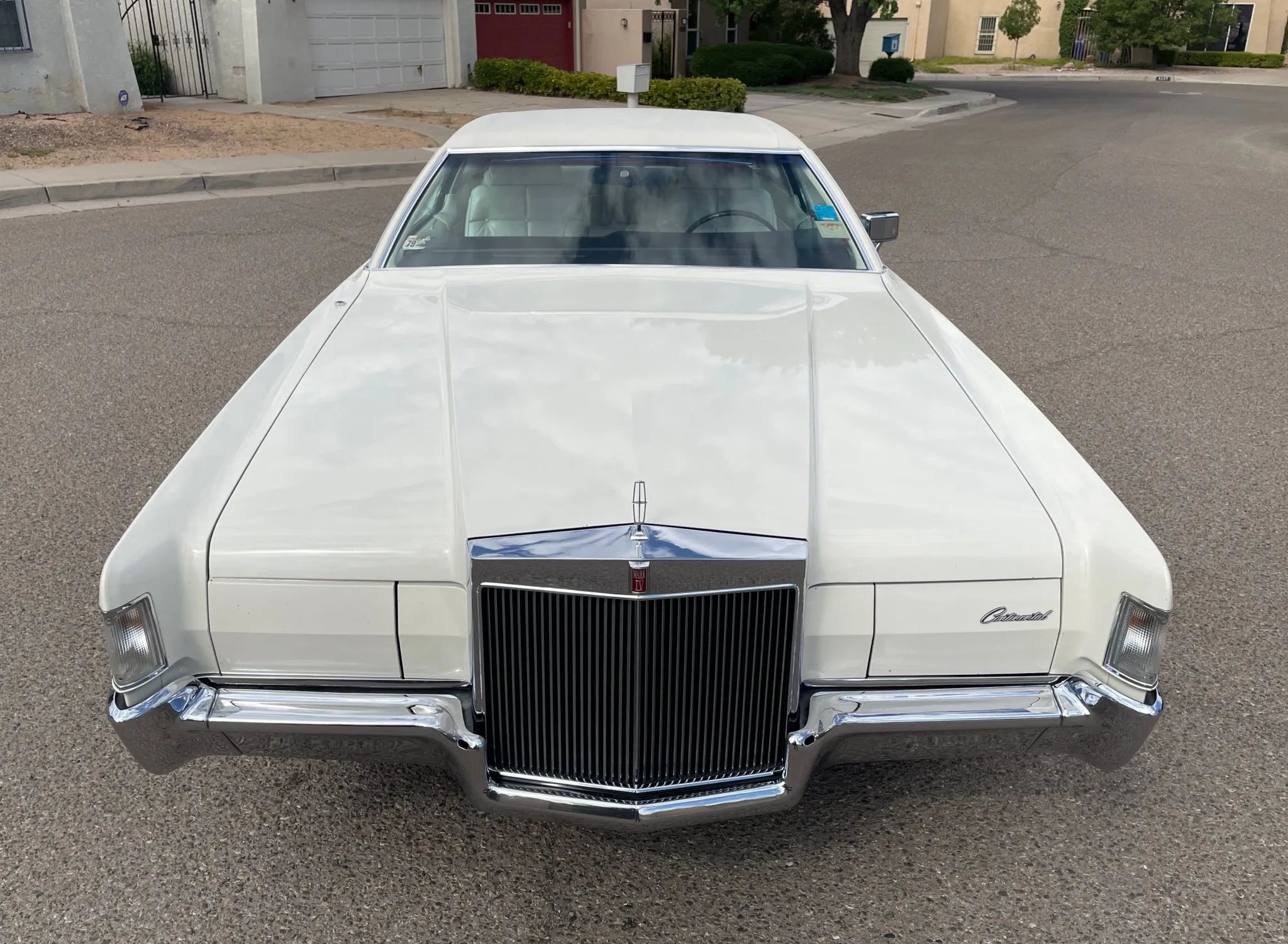 Front view of a white 1972 Mark IV, showing off its long nose