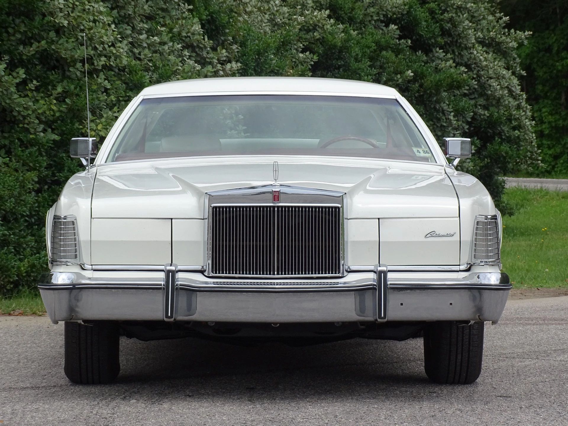 Front view of a white-on-white 1975 Mark IV