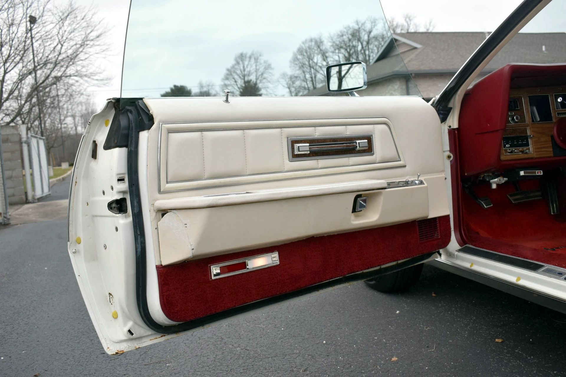 Open driver's door of a white 1975 Mark IV