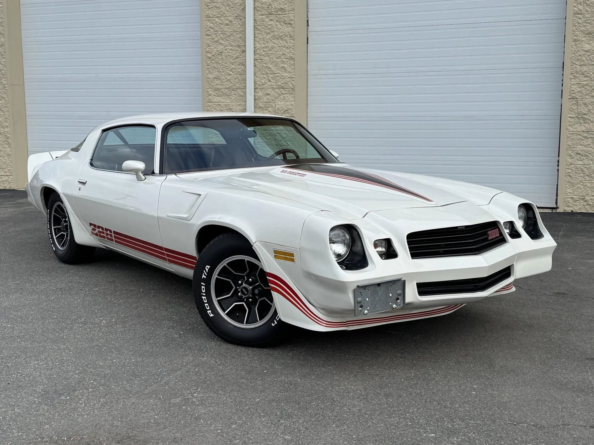 Right front 3q view of a white 1980 Chevrolet Camaro Z28 with red stripes
