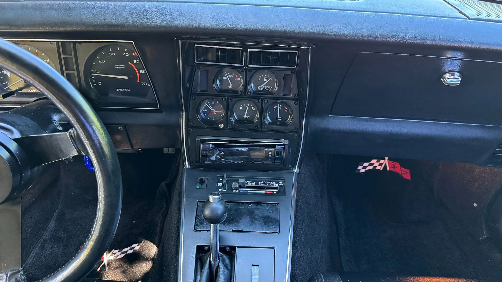 Center stack gauges and automatic shifter in a black Corvette