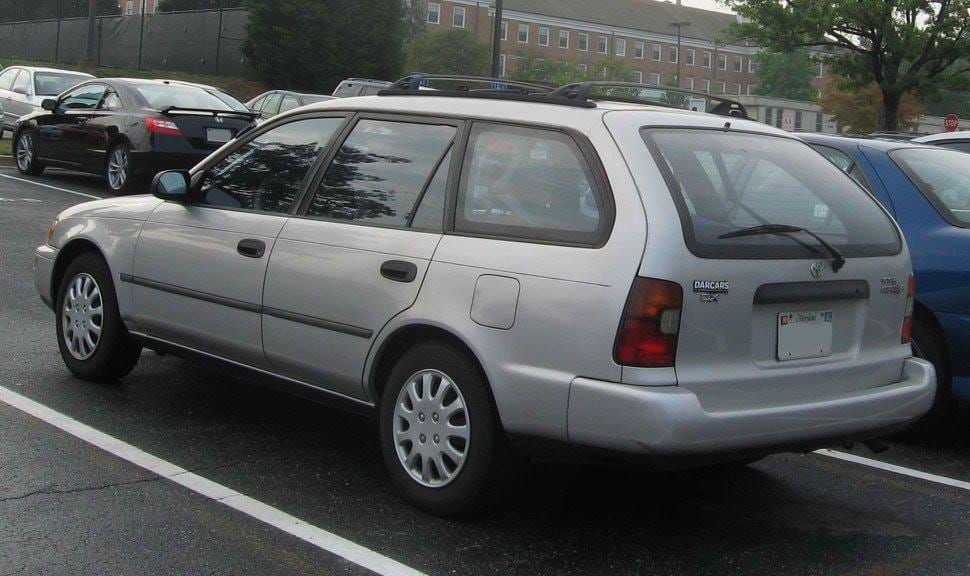 3/4 rear view of a gray 1994 Corolla wagon in a parking lot.
