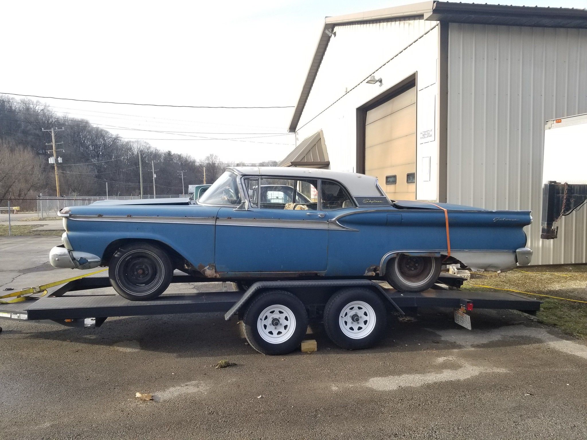 Image of derelict blue 1959 Ford Galaxie Skyliner on a trailer