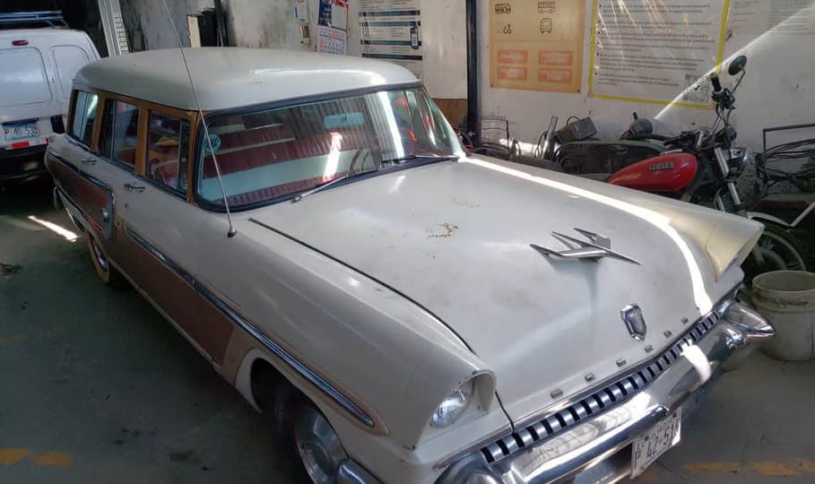 Photo of a white 1955 Mercury Monterey station wagon in a garage