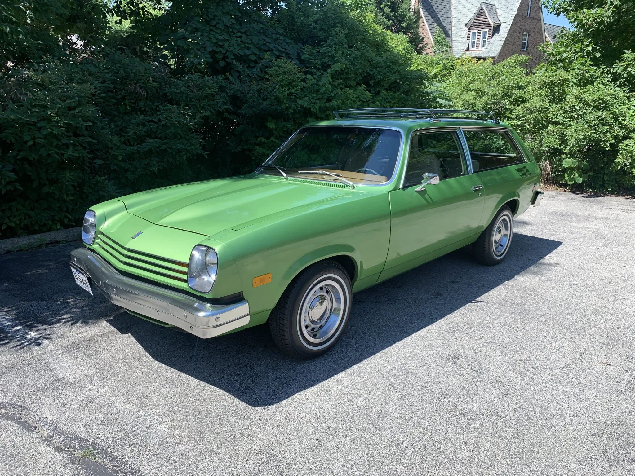 Image of Lime Green 1976 Chevrolet Vega Kammback in a verdant corner of bushes