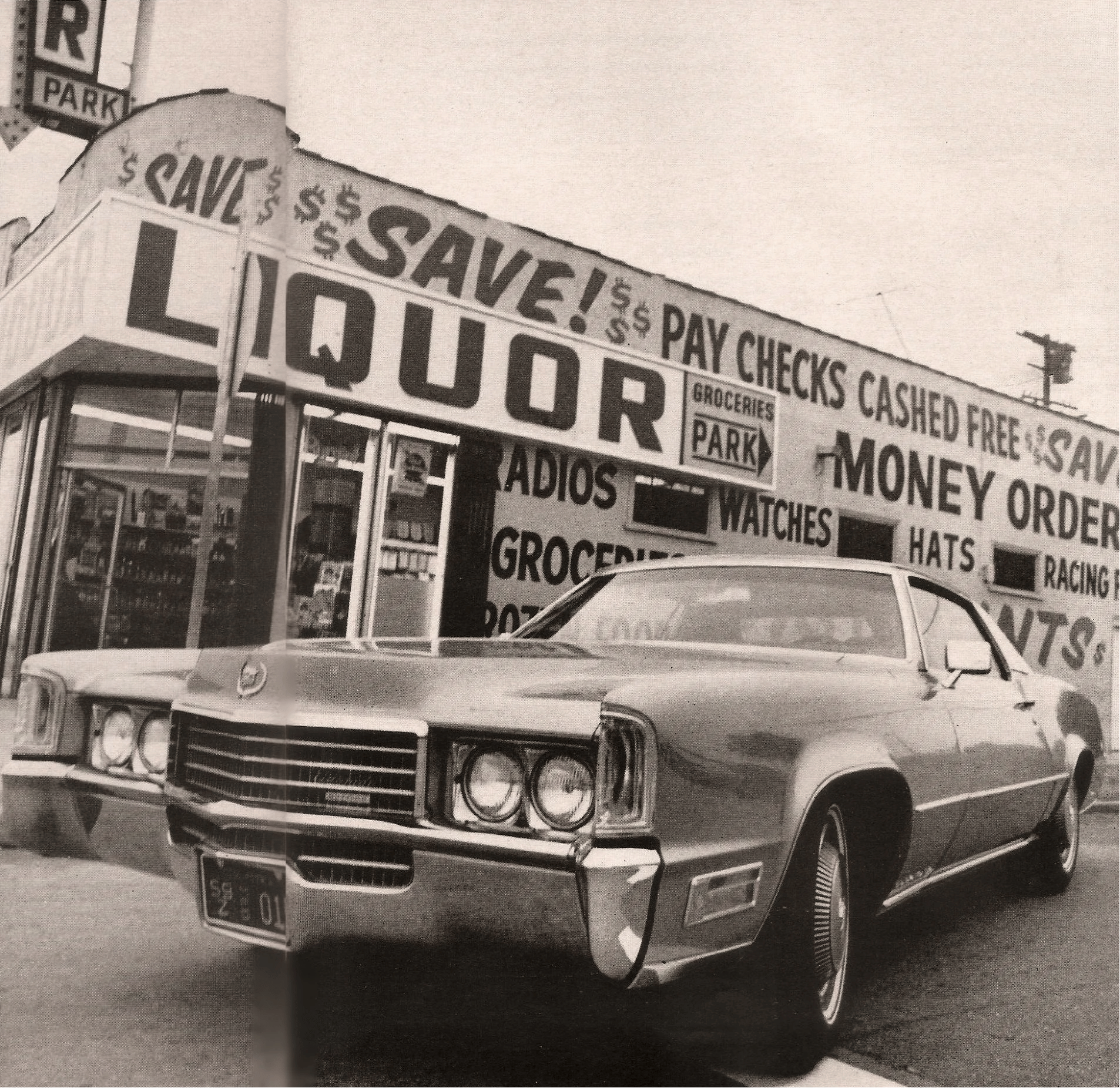 Vintage C/D Review: 1970 Cadillac Eldorado Was Powerful, Pricey, and Prestigious – So, Why Did They Photograph It Outside A Check-Cashing Place? 1 B&W photo of a 1970 Cadillac Eldorado parked in front of a liquor store with signs advertising paycheck cashing and money orders