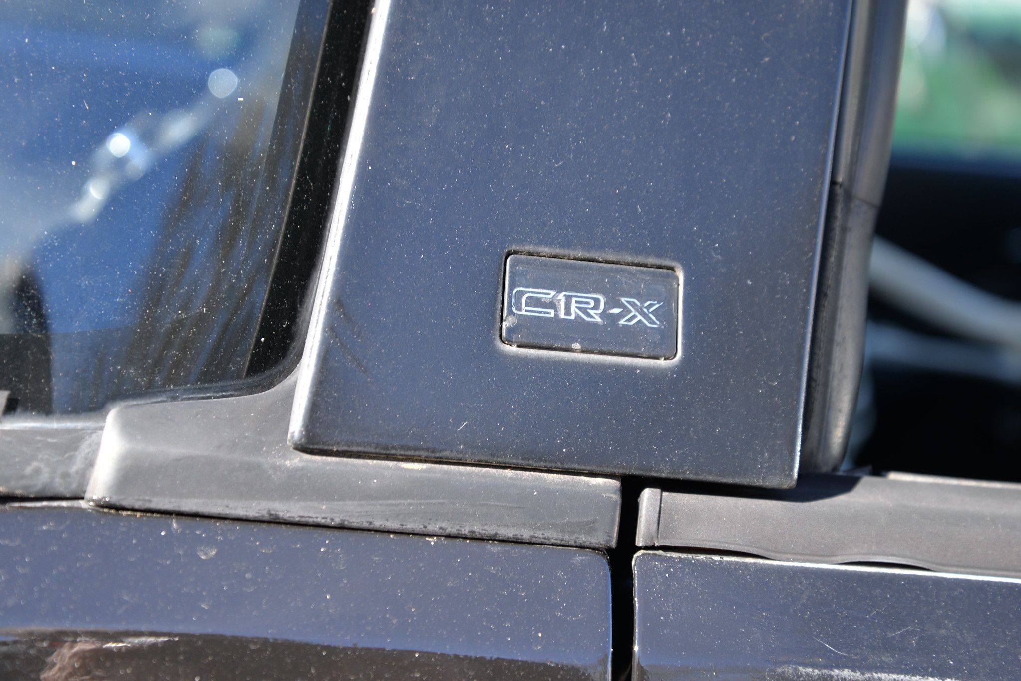 "CR-X" badge on a black 1985 Honda CRX