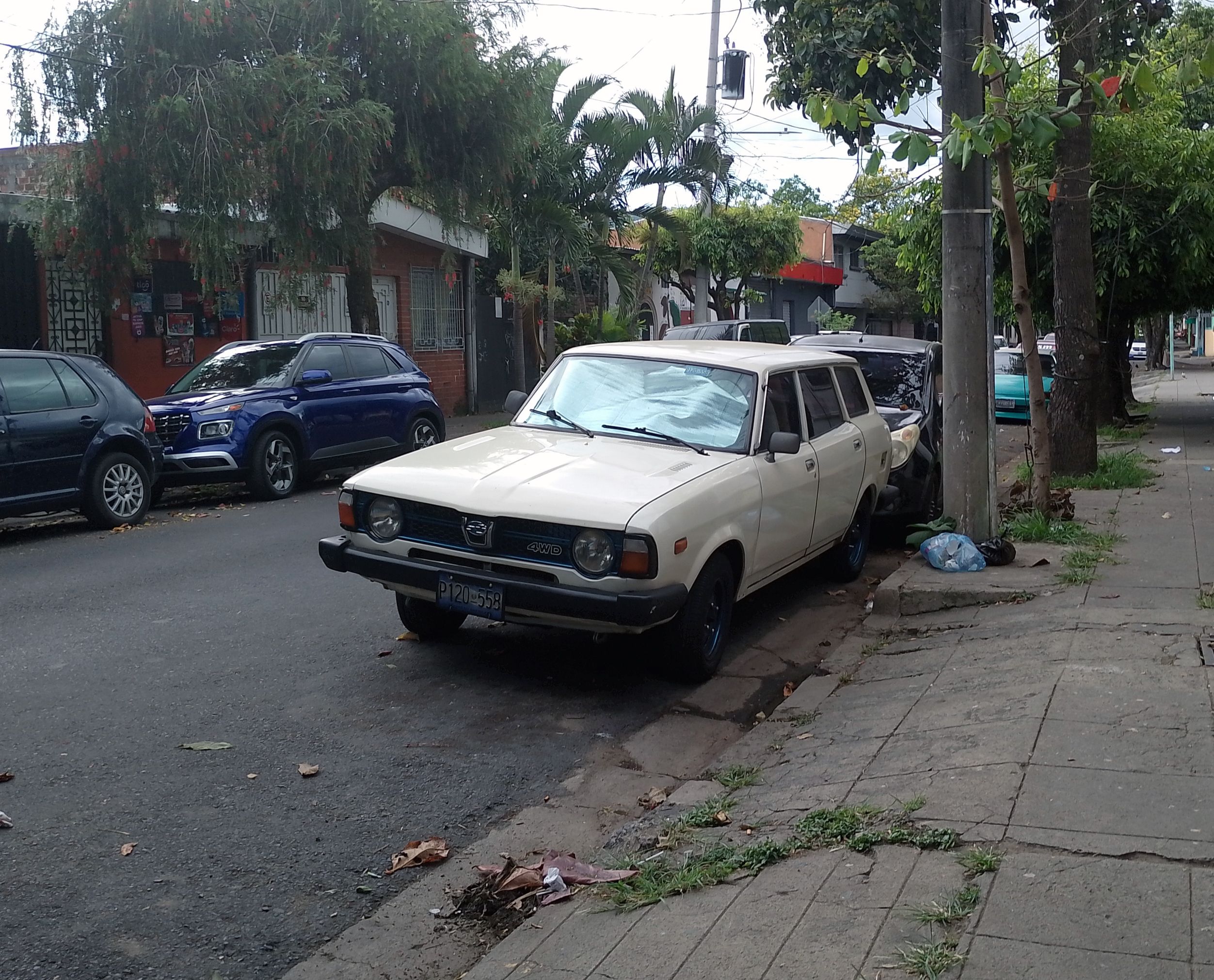 Photo of a well-preserved white 1978 Subaru Leone station wagon parked on the street