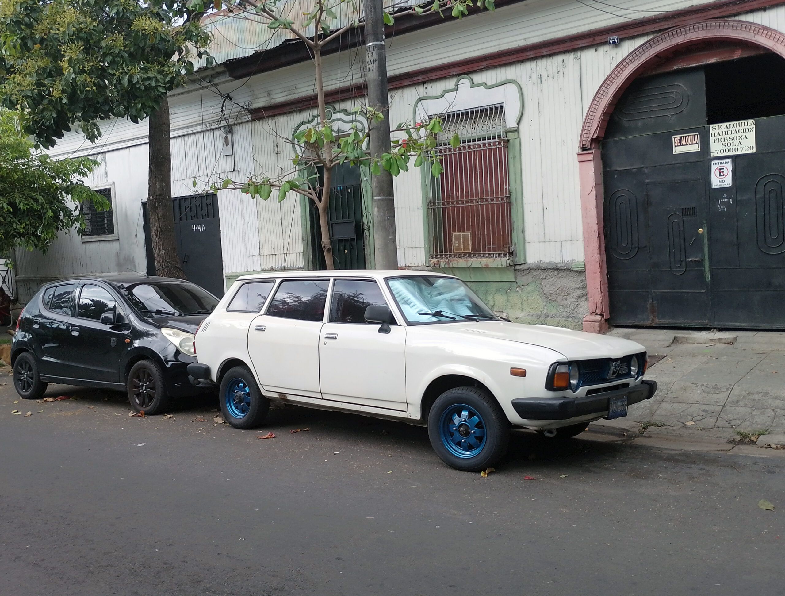Photo of a well-preserved white 1978 Subaru Leone station wagon parked on the street