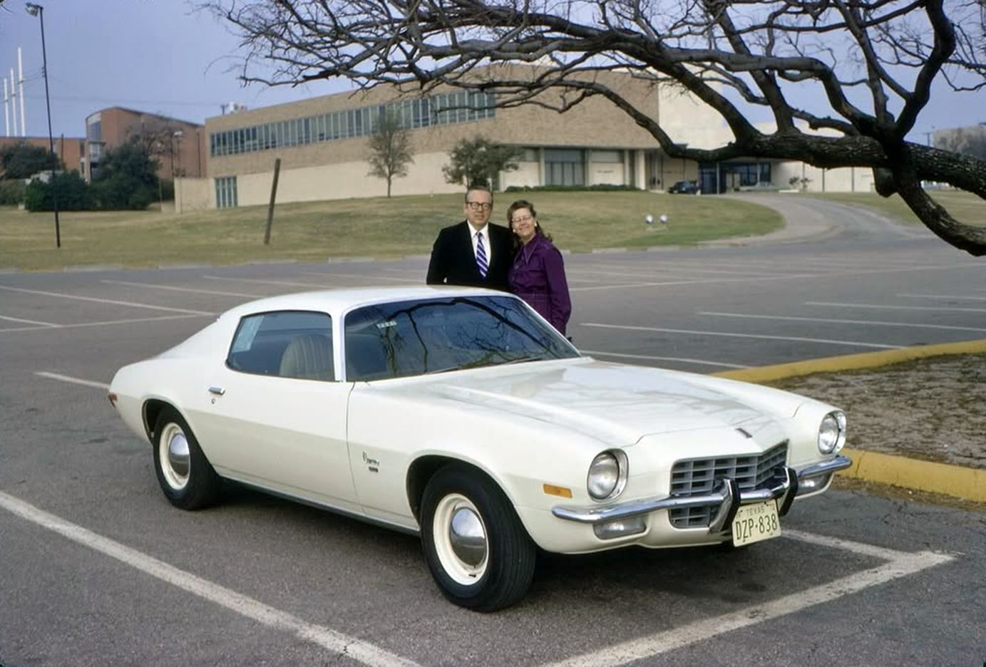 Vintage Photos Of Chevrolet In The 1960s & 1970s: An American Icon In Its Heyday 1 Photo of an older couple posing behind a white 1973 Chevrolet Camaro